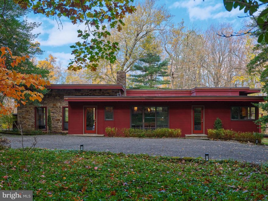 Welcome to this spectacular MID-CENTURY MODERN architectural gem!  Tucked down a private drive in complete privacy, you'll be captivated by this stunning Jericho Mountain setting.  Situated midway between New Hope and Newtown, this 6.2 acre wooded lot offers stunning four-season views, relaxing solitude, and proximity to everyday conveniences.  Entering the stunning Great Room, you will be taken by the soaring wood ceiling, massive exposed structural beams, and expansive glassline offering breathtaking views of the sunny lawn bordered by woods.  The clean lines, period light fixtures, and wood-burning stone fireplace create a wonderful palate for your furnishings and artwork.  Step out on the expansive deck to experience the peace and beauty of this stunning location.  The adjacent Dining Room provides connectivity to the Great Room, views to the wooded exterior, and is the perfect gathering spot for family and friends.   The large Kitchen with original Mid-Century cabinetry features abundant work surfaces and storage, with plenty of room for table or island.  A convenient pass-though to the Dining Room is a nod to the architectural purity of this home.  A convenient Laundry Room is just off the Kitchen.   A beautifully updated main floor Powder Room with exposed stone wall adds to your convenience.  Upstairs a half flight of stairs, you'll find an expansive Den or Office, with period built-ins, outdoor views, and access to the deck.  A perfect space for relaxation, working, or working out.  The adjacent Primary Bedroom offers abundant closet space, period built-ins, and charming desk nook with beautiful views.  The stunning Primary Bath with high-end finishes offers a lux hotel-quality experience with double-sink vanity, spacious shower, and separate soaking tub.   A spiral staircase leads you to the walk-out lower level,  featuring a Recreation room perfect for games, hobbies, or lounging.  Two large bedrooms and updated full bath make this level a wonderful private space perfect for guests or family members.   All updates to this home have been done with great respect for the architectural purity of the Mid-Century design.  Idyllic indoor-outdoor living.... easy multi-room access to the expansive deck, with relaxed transition to a moss-punctuated stone patio with outdoor fireplace....the perfect gathering spot on chilly evenings!  This 5-star location is convenient to Princeton, Philadelphia, and New York via road or rail.  This is a very special property in a very special location.... an opportunity like this presents itself very rarely.  Make your appointment to see it today.