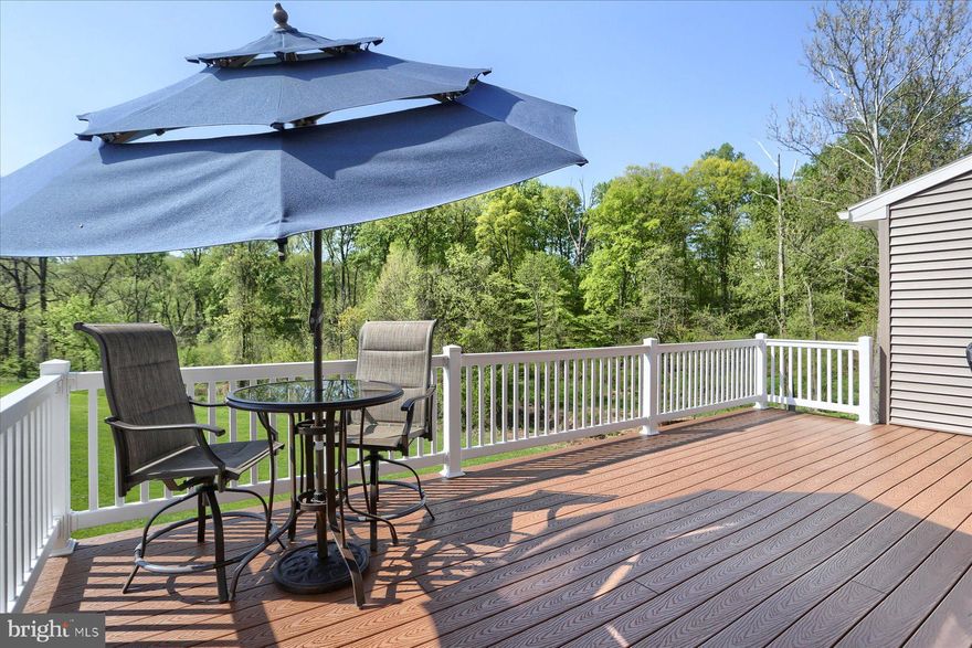 One owner custom townhouse with opulent upgrades and spacious nature views.  Setting in a cul-de-sac within the desirable confines of Winding Hill's Hanbury Court, this custom home is filled with convenience and detailed practicality.
This home showcases upgraded kitchen cabinetry with elegant crown molding, under and above cabinet lighting, quartz countertops complemented by a tile backsplash, and stainless-steel appliances with a farmhouse sink.  Gorgeous selected hardwood flooring throughout greets you by gracing the foyer and extends through the kitchen and into the gathering area, creating a seamless flow.  then step through your paned sliding glass door onto an expansive 12x18 maintenance-free composite deck peacefully overlooking the woods and creek.
The second floor is dedicated to all three bedrooms, two full bathrooms, and a finished laundry room complete with the state-of-art front-load washer and dryer, ensuring convenient and efficient laundry chores.  Noteworthy, the owner's suite boasts an expansive walk-in closet that features a California Closet design and a custom walk-in shower accompanied with his/her sinks.
The finished basement with crown molding offers many options as a recreation room, office and/or bedroom, creating a space that perfectly suits your needs and desires.  It has separate zone climate control and extra insulation between its ceiling and the main floor.  This area includes a separate walk-in storage room with floor to ceiling built-in wooden shelves, and a handy walk-out to a 12x18 poured concrete porch / patio overlooking the woods.
Other custom items of interest include soft-close drawers/cabinets thru-out the home, an in-wall electric fireplace in the gathering room, wall-mounted flat screen TVs (gathering room / living room  & basement) with behind the wall HDMI cable wiring, Hunter Douglas blinds, and a garage refrigerator.  All 3 bathrooms are equipped with comfort height vanities & commodes.  Also, there is a whole home water treatment system with softener and RO safe purification as well as a tankless water heater.  Enter the home through the two-car finished garage, equipped with an upgraded belt-driven opener for quiet and reliable access.
This neighborhood is packed with lots of outdoor spaces.  Winding Hill boasts acres of preserved woodlands (like the view from the deck), hiking trails, community parks, pickle ball, and a clubhouse with a pool just a short walk away, making it a truly remarkable place to call home.