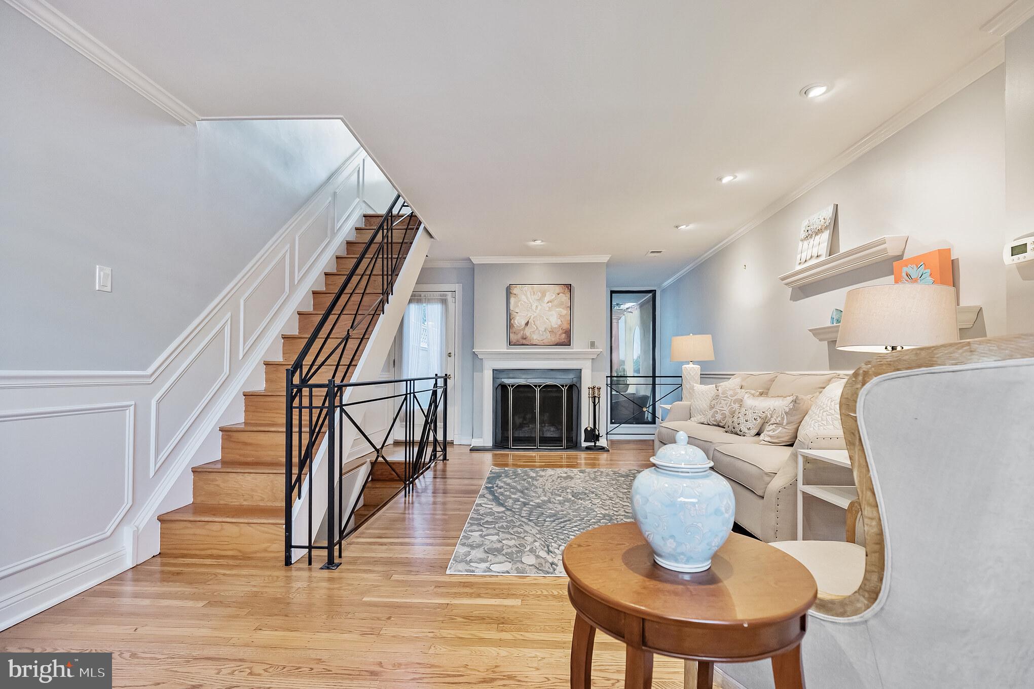 MOTIVATED SELLER - LOOKING FOR OFFERS! Welcome to Queen Village! Come home to the “prettiest house on the block”. Location, Location, Location: *in the award winning William M. Meredith School Catchment, *with a 100 pt. walking score, *close to amazing restaurants, coffee shops, boutiques, and historic Independence Park. This is city life at its best! From the moment you enter. the foyer with its double coat closet, you’ll be right at home. The expansive living room invites you in to enjoy the handsome hardwood floors, sit down and warm your feet at the roaring fireplace (yes it works!). Your balcony overlooks the formal dining room. Step outside to the patio with a fabulous outdoor kitchen (30 in. propane grill, separate burner and 4.1 cf refrigerator) and beautiful arbor that make an ideal space for dining al-fresco. Not only a relaxing oasis for enjoying your morning coffee but an entertaining space for family and friends. The Patio furniture is included. Downstairs to a 2-story dining room with Swarovski crystal chandelier and plenty of natural light from the south-facing clerestory windows. Do you cook? Next on your list, A fabulous chef's kitchen that balances practicality with sophistication. It features white custom cabinetry with full reveal, self-closing drawers, quartz countertops, a Liebherr refrigerator and under counter 48-bottle wine refrigerator. The Bosche induction range makes cooking a delight. A microwave for when you need it fast and dishwasher for an easy clean-up. And…you must see the superb pantry with 5 turntables and shelves in the upper section and 3 pull-out drawers in the lower section providing PLENTY of organization and storage. There is a convenient powder room and a laundry/utility room featuring a Bosche stackable W/D, stainless steel racks are included for additional storage and finally, there is dual-zone wine storage for over 200 bottles that completes this level. Take a walk up to the second floor which features an ensuite bedroom with spacious hall closets and a large spa bathroom with jetted tub, rainforest shower head, and adjustable lighting - the Marriot would be proud. There is a stunning den/family room/office featuring great natural light, an electric fireplace with quartz mantle, built-in cabinetry, quartz counters and a beverage refrigerator - the perfect venue for watching Eagles football or binge-watching classic movies.  The third-floor features two bedrooms - a soothing primary bedroom suite with walk-in closet and ensuite bath with rainforest shower head, and an additional bedroom with terrific natural light that could be used as an office, workout space or nursery. This home has been lovingly maintained- freshly repainted inside and out and brickwork repointed. Upgrades include custom window shades throughout - motorized shades in den and office and blackout shades in primary bedroom. Other upgrades include wrought-iron banisters, custom cabinetry, high-end finishes, hardwood floors, crown molding, wainscoting, and recessed lighting with dimmers throughout. This is everything you dream of when you think of city living.
