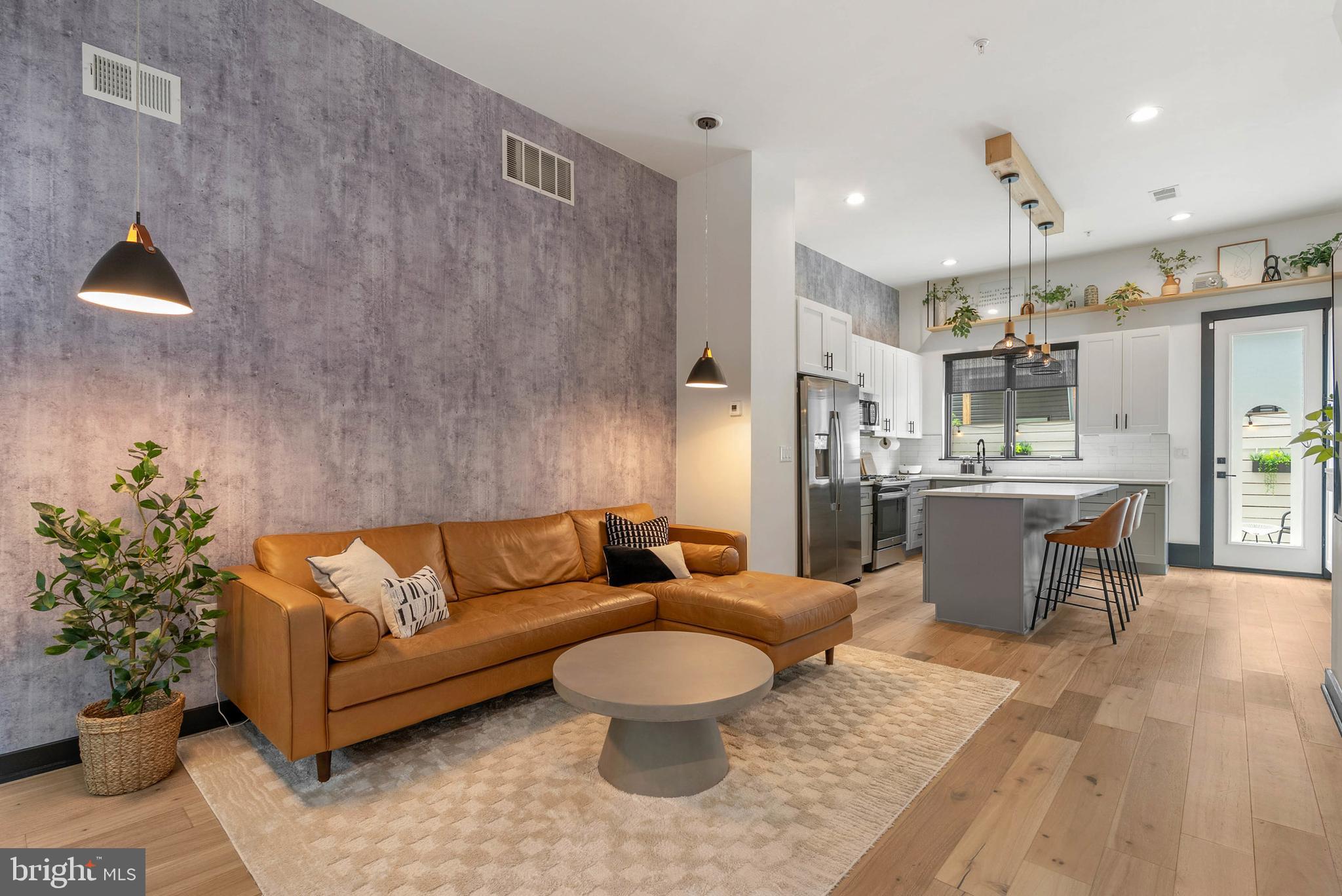 When opening the front door, only use the physical key from the lockbox and do not use the digital keypad. This 17-foot-wide luxury residence in the heart of Norris Square is unlike any other on the block, thoughtfully upgraded to create a truly one-of-a-kind home. Featuring 3 bedrooms, 3 full bathrooms, a finished basement, rear patio, and roof deck with Center City views, the home seamlessly blends modern design with custom artistry throughout. Inside, soaring 12-foot ceilings on the main level and 9–10-foot ceilings on all other floors create an airy, open feel, and every room has been enhanced with designer finishes and custom features. Highlights include hand-painted murals, custom wallpaper installations, storage built-ins throughout, upgraded lighting and hardware, and bespoke white oak shelving and beams in the kitchen that add both warmth and sophistication. The basement has been reimagined as a fully-equipped in-home gym, and both the roof deck and back patio have been transformed into stylish outdoor retreats. Every detail has been intentionally curated, ensuring both style and functionality at every turn. Adding to its value, the property comes with five years remaining on the tax abatement, providing significant savings for the new owner. Perfectly located just steps from Fishtown’s vibrant dining scene and local attractions, this home combines convenience with unmatched individuality. A comprehensive list of upgrades is available upon request to showcase the full scope of this home’s exceptional enhancements.
