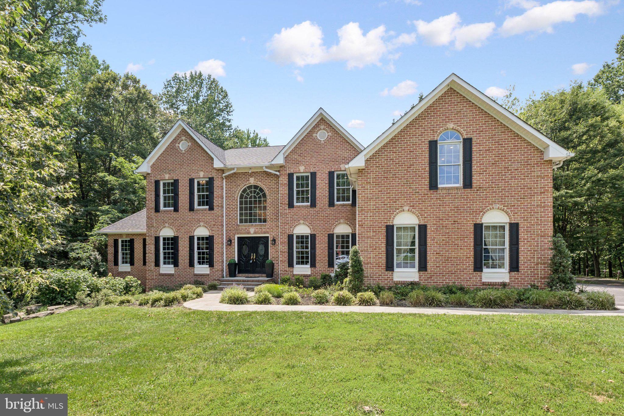 Welcome to your stunning brick-front estate, where timeless elegance meets modern comfort. A grand entryway sets the tone for the exceptional interior, featuring formal living and dining rooms ideal for entertaining. The sun-filled conservatory offers a serene retreat, while the main-level office provides the perfect work-from-home space. At the heart of the home is a gourmet kitchen designed to impress, boasting a massive island, quartz countertops, double pantries, and an inviting morning room. Adjacent, the great room offers soaring ceilings and a cozy fireplace, creating an open and inviting living area. Additional main-level highlights include a convenient laundry room, powder room, and an oversized 3-car garage. Upstairs, discover four spacious bedrooms and three full baths, including a luxurious primary suite complete with a sitting room, romantic double-sided fireplace, dramatic tray ceiling with accent lighting, and a custom walk-in closet flanked by two private storage rooms. The spa-inspired primary bath features double sinks, a soaking tub, and a separate shower. The second bedroom enjoys a private ensuite, while the third and fourth bedrooms share a stylish buddy bath. The expansive lower level is a true entertainer’s dream—featuring multiple gathering areas, including a gaming zone, media/theatre space, and a spectacular full-service wet bar with granite countertops, refrigerator, stove, microwave, ice maker, and seating for all of your guests. There’s even room for a pool table and casual lounging areas, all flowing out to the beautifully landscaped backyard. Outdoor living is equally impressive with a spacious deck off the kitchen, overlooking a lush grassy yard framed by mature privacy trees. Ideally located with easy access to major commuter routes, shopping, dining, and everything you need—this exceptional residence truly has it all.