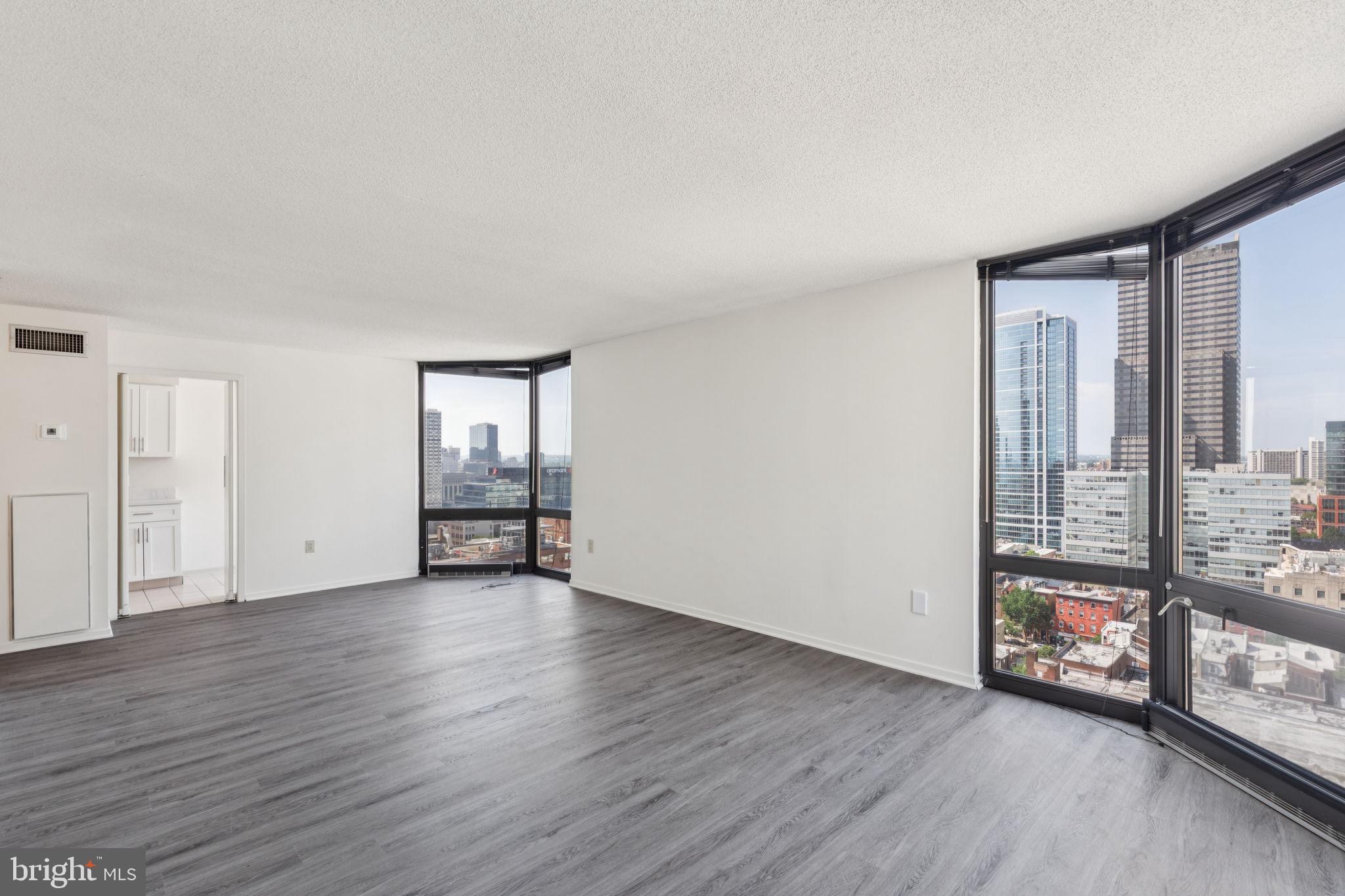 Luxurious two bedroom residence on a high floor with floor-to-ceiling bay windows offering panoramic views of the Center City skyline and Rittenhouse Square! The spacious living/dining room is beaming with natural light due to large bay windows, providing excellent entertaining space. Adjacent to the living/dining area, the eat-in kitchen features stainless steel appliances and neutral cabinetry and countertops. Both bedrooms have floor-to-ceiling windows, incredible closet space, and their own bathrooms. Additionally highlights include a stackable washer/dryer and new wood-like floors throughout. The Wanamaker House is located one block from Rittenhouse Square and provides easy access to both Center City and University City; residents enjoy a 24-hour doorman, a seasonal rooftop pool, a fitness center, and a parking garage available for an additional fee (subject to availability). All common areas were recently renovated including the lobby, hallways, meeting room, amenity lounge, and fitness center, designed by world- renowned architect Cecil Baker.