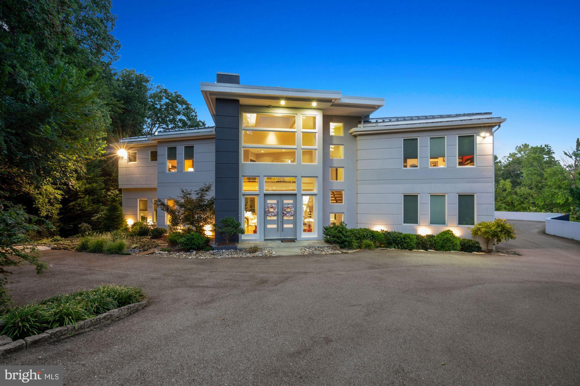 Contemporary splendor abounds in this artfully designed residence and guest house, sited on
two glorious acres including swimming pool, entertaining decks, tennis courts, multiple
garages and courtyard parking large enough for another 10-12 cars. The finest finishes were
thoughtfully used in the architecture and building of this timeless home. The captivating main
residence offers an open floorplan with two story foyer, lavish living room and dining room,
double home offices, a cooks delight of a kitchen, family room and first level guest bedroom
suite. The second level of the home boasts an owners dream bedroom with his and her baths,
huge walk in closet and large upstairs laundry. Another three bedrooms each with ensuite bath
and upstairs family room lead to an upstairs outdoor terrace that overlooks the grounds.
Wow is the best way to describe the lower level entertaining area, bar and surprise high
ceilinged screen porch opening to the swimming pool area and walkways to the guest house.
The daylight walkout lower level of the main home includes another two bedrooms each with private bath, and an unfinished room designed to be a large home theatre. The bonus guest house is simply
incredible with two bedrooms and two full baths, living room, dining room, kitchen and additional
garage parking..........amazing spaces, well designed for today’s living and lush green views
abound. This one is a ten......a contemporary lovers dream home. Hurry this one won’t last!