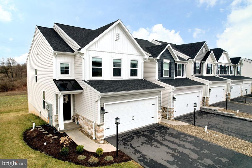 Welcome to this beautifully designed end-unit townhome in the desirable Harvest Meadows community, offering three levels of thoughtfully finished living space. The open-concept main floor is ideal for both everyday living and entertaining, featuring a spacious kitchen with upgraded cabinetry, an expanded family room with a bump-out for additional living space, and a bright dining area that leads to a 10x10 deck with stunning views, all complemented by stylish flooring throughout.  A convenient powder room and welcoming entry complete the main level. Upstairs, the owner’s suite offers a private retreat with a bump-out that creates an extended sitting area - perfect for a home office or lounge space - along with a walk-in closet and an en-suite bath featuring a double vanity and tiled shower. Two additional bedrooms, a full hall bath, and a full-size laundry room provide comfort and convenience. The finished walkout lower level adds exceptional flexibility, complete with a full bath and generous living space ideal for guests, extended stays, or additional recreation. Conveniently located near Beaver Stadium, Penn State, North Atherton shopping, the State College Airport, and downtown State College, this well-appointed townhome is perfect for full-time living or a Penn State getaway, all within a popular and thoughtfully planned community.