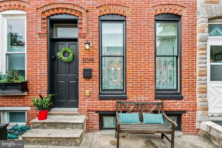 Welcome to 3019 Keswick Rd, a beautifully updated home nestled in the heart of Hampden—one of Baltimore’s most sought-after neighborhoods known for its charm, character, and vibrant local scene. This 2-bedroom, 2-bath residence blends classic Baltimore style with modern upgrades, creating a warm and inviting space you’ll love coming home to.

Step inside to an open and airy floorplan designed for both everyday living and effortless entertaining. The gourmet kitchen is a true standout, featuring stainless steel appliances, gleaming countertops, and eye-catching exposed brick accents that add a touch of historic charm. The seamless flow between living, dining, and kitchen spaces makes hosting a breeze.

Upstairs, the spacious primary suite offers a relaxing retreat with vaulted ceilings that enhance the sense of space and light. The ensuite bathroom is timeless and elegant, complete with a classic subway-tiled shower with a rain head and striking black-and-white hex tile flooring.

A full-width, full-length basement provides exceptional storage and future potential. Featuring a finished laundry area with washer and dryer, the remaining unfinished space offers flexibility for storage, hobbies, or future expansion.

Outdoor living is just as impressive. Enjoy your morning coffee or unwind in the evening on the covered back deck, perfect for year-round entertaining. The fully fenced rear yard provides privacy and a rare bonus—backing directly to Wyman Park for peaceful, tree-lined views and easy access to nature.

With its unbeatable location, stylish finishes, and thoughtful features throughout, this Hampden gem offers the perfect blend of city living and everyday comfort. Don’t miss the opportunity to make it yours!