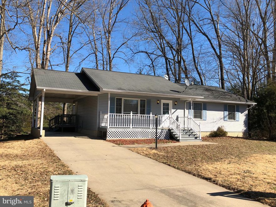 Conveniently  located 5 minutes from NSWC Dahlgren and 5 minutes to the NICE bridge!  Sit back on your full front porch or relax on your back deck overlooking Williams Creek. Spacious one level living with hardwood and laminate flooring on entire main level. Open kitchen with island and tons of cabinet space. Partially finished basement affords you a recreation room that leads out to a patio, optional 4th bedroom, workshop and private office (vanity in picture is not connected)