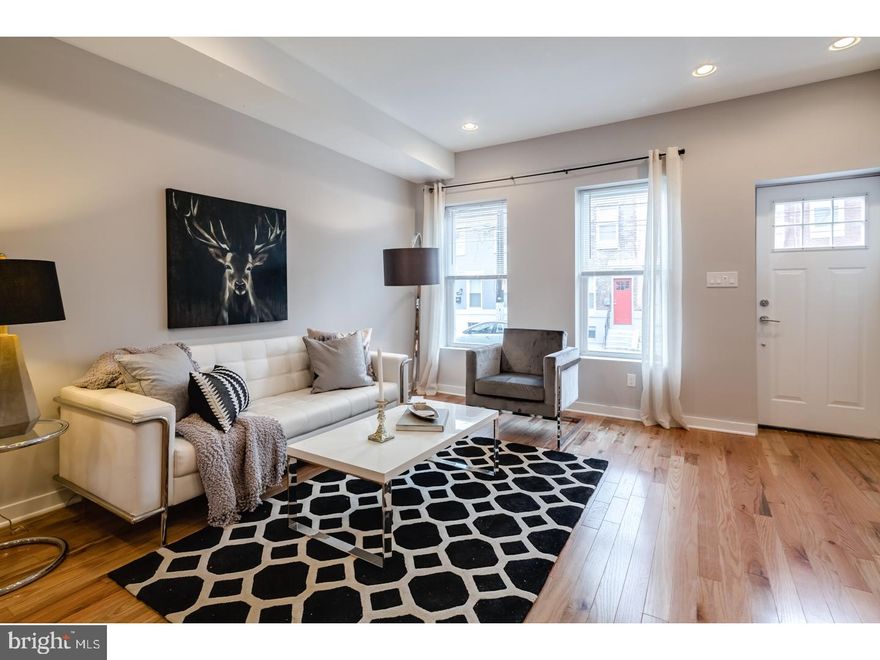 Stunning renovation by one of the city's best custom builders. with lots of open space, generous sized rooms and luxury throughout., tons of  windows drenching the entire home with natural light. Gorgeous kitchen w/ designer cabinets, granite counters ,stainless steel appliance package and tiled backsplash. Also, hardwood floors, great ceiling height and iron railing system.wide open floorplan with enough space for a huge kitchen, large dining room and very spacious living room. The lower level has a meticulous finished living room/den with tiles floors, windows, tall ceiling heights - this room is also perfect for a 4th bedroom, The 2nd floor has 3 bedrooms with great closet space, hardwood floors and magnificent tiled  bathroom. The bathroom has floating designer vanities, tiled shower and beautiful high end fixtures and craftsmanship. Luxury finishes and amenities throughout this perfect home. and its Tax abatement pending, super low taxes. Walk everywhere! dont delay your visit to this one, it will sell fast.