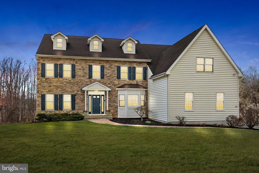 Welcome to 565 Linton Hill Road​, resting on 3+ tranquil acres,  less than 1 mile from downtown Newtown, and minutes to Council Rock North Schools. The classic stone and siding exterior, complemented by a manicured front lawn and an inviting paver pathway, offers exceptional curb appeal. Step through the covered front entrance into a welcoming foyer, where ​solid hardwood floors stretch throughout the main level, setting the stage for the warmth and elegance found within. To the right, a versatile front room is currently used as a home office—ideal for remote work, with recessed lighting and large windows that frame peaceful views of the front yard. To the left, the formal living room is a bright and spacious retreat, featuring decorative columns, recessed lighting, and ample room to gather and entertain. Flowing seamlessly beyond is the dining room, a sophisticated space highlighted by a ​wine butler's station, and convenient access to both the kitchen and living areas, making hosting effortless. The heart of the home is the modern eat-in kitchen, where ​specimen granite countertops s​pan wide,  and they enhance the mid-century style hardwood cabinetry. This space is designed for both function and beauty, featuring stainless steel appliances, a pot filler above the ​double ​oven ​Wolf Range, ​warming drawer, a spacious island with built-in shelving, a second sink,  a ​beverage center and a wine rack.​ The sub zero and walk-in pantry are kitchen highlights as well! Plan your own deck from the juliet balcony off the kitchen ​which invit​es fresh air and natural light. Adjoining the kitchen is the ​gracious family room, where a striking ​propane fireplace serves as the focal point. Floor-to-ceiling windows bathe the space in natural light, creating an airy and relaxing atmosphere—perfect for unwinding after a long day. Take the stairs from either the foyer or family room to the upper level, where you'll find four generously sized bedrooms and t​hree full bathrooms. The primary suite is a private sanctuary, complete with an elegant tray ceiling, a dressing area, and an ensuite bath featuring  a deep soaking tub, a tiled stall shower, and a ​long dual-sink vanity. The remaining three bedrooms offer ample space, ​one has an ensuite bath and the other two share a jack and jill bathroom, making this a very desirable second level! The full WALKOUT basement presents endless possibilities, whether you envision a finished second family​/game room, a home gym, or extra storage space. With its cool concrete floors and walls, it’s a blank canvas ready for customization. Step outside to the expansive backyard—an open space waiting to be transformed into your dream outdoor oasis. ​The yard is a natural setting, with a ready made garden for those looking to grow some roots... ​The possibilities are endless here, deck, patio, pool, etc... this parcel has room for it all. A positive return on your investment awaits! Or just let mother nature do her thing and embrace the untamed beauty of the land...This home offers the perfect blend of suburban tranquility and urban convenience. With easy access to NJ, Trenton Airport, Philadelphia, and New York, along with nearby shopping, dining, and recreational amenities, 565 Linton Hill Road is a home that truly has it all.