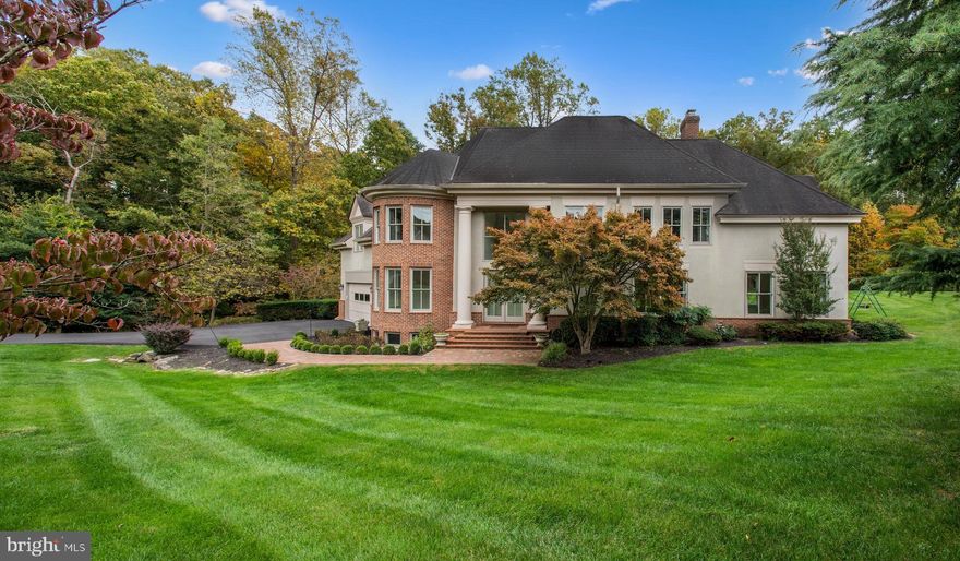 This exceptional property is peacefully situated in a cul-de-sac, mere minutes away from the Great Falls Village Shopping Center. It effortlessly harmonizes elegance, practicality, and the beauty of nature. The interior is flooded with natural light, adorned with lofty ceilings, and adorned with distinctive Turret windows that define its unique character.

The main entrance foyer features impressive two-story columns and a striking brick front walk. To the left, a versatile space with Turret windows can become an elegant office or formal sitting area. French doors connect the brick patio, creating a perfect spot for entertaining in the living room with a contemporary granite fireplace.

The second floor features four bedrooms, including a luxurious primary bedroom with cathedral ceiling, fireplace, private balcony, and a luxurious bathroom. The walkout basement offers entertainment space, a game room, and a well-appointed bar.