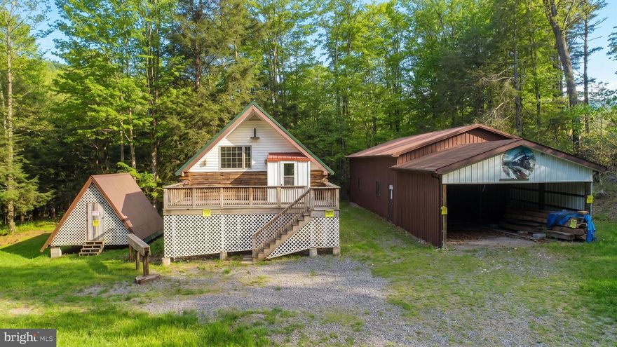 Nestled in the scenic countryside of Southern Garrett County, on 5+ acre property along North Fork Sand Run, this  two-level home provides a solid foundation for renovation or customization, making it ideal for a full-time residence or  mountain getaway. In addition to the home, the property features a large detached garage perfect for vehicles, equipment, hobbies, or workshop space, along with a separate storage building for added convenience. Public water service is already in place, and county road frontage allows for easy year-round access. With ample acreage for recreation, gardening, or future improvements, this property presents endless possibilities for buyers looking to create their own retreat in the mountains of Western Maryland. Call today for your private showing.