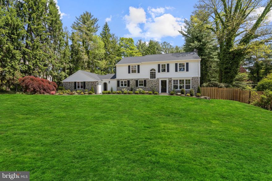 1611 Lark Lane, Villanova — Completely reimagined and renovated inside and out, this exceptional 4 bedroom, 4 full and 1 half bath home blends the comfort and functionality of a newly built luxury residence with the timeless charm of its stone exterior and sought-after neighborhood setting. Situated on an almost one-acre level lot on a private cul-de-sac street within the top-ranked Lower Merion School District, this move-in ready home showcases high-end finishes throughout all three finished levels.
The home’s curb appeal impresses with beautiful original stonework, inviting arched breezeway, and extensive exterior improvements including new roof, gutters, windows, siding, shutters, Therma-Tru exterior doors, driveway, flagstone walkway, refreshed landscaping and lawn.
Enter into the welcoming foyer featuring rich-toned refinished hardwood floors that are throughout most of the home. A dramatic arched window illuminates the redesigned staircase with new railings and spindles, beadboard accents, and designer sconces. The home also features all new interior and exterior doors, trim work, fresh neutral paint, and designer lighting throughout.
Fully renovated with exceptional attention to detail, every inch of this home was redesigned for today’s lifestyle. Reimagined spaces created an open living area centered around the family room, chef’s kitchen, and breakfast room. The beautiful windows allow loads of natural light throughout the home.
The family room features updated arched built-ins, recessed lighting, fireplace with new gas insert, and wall of windows overlooking the private rear setting. The chef’s kitchen includes an 11-foot island with seating for five, 3-inch Calcutta countertops, Calcutta backsplash, white shaker cabinetry with pantry storage, gold hardware, recessed lighting, dry bar with glass-front cabinetry, and premium appliances, including Liebherr paneled refrigerator, Thor 6-burner range with griddle, paneled dishwasher, beverage refrigerator, and microwave drawer. The breakfast room is a true showstopper featuring a statement chandelier and custom banquette seating for ten surrounded by windows on three sides. Sliding doors connect beautifully to the rear slate patio. 
Additional main level highlights include a formal dining room, which could also serve as an impressive office, off the foyer with triple front windows and deep sills. A long front hallway leads to an elegant powder room, private library room with French doors, and huge mudroom with slate flooring, built-in cubbies, bench seating, storage cabinets, and two large closets. A side entrance opens to the breezeway and attached two-car garage.
Upstairs, the primary suite offers peaceful views and exceptional storage with two closets anchored by a window seat plus an additional walk-in closet. The marble ensuite bath features marble tile flooring, soaking tub, oversized walk-in shower with Hansgrohe fixtures and massage settings, double fluted vanity with built-in hair dryer drawer, and water closet. The newly installed second ensuite bedroom includes its own marble bath, adding another full bathroom to the home. Bedrooms three and four share a renovated hall bath with marble floor, bathtub plus double sink vanity. A second-floor laundry with built-in storage is conveniently located off the spacious hall.
The fully finished lower level features newly installed light-toned LVP flooring and flexible living space including a large bonus room with refreshed full bath, yoga / workout room, utility room with sink, and additional storage space.
Outside, the fenced in-ground pool updated in 2024, flagstone patio, and landscaped rear yard create the perfect outdoor retreat. Additional updates include new HVAC and garage doors (2024),  
Conveniently located near Villanova train station, shopping, dining, and major commuting routes, this move-in ready home offers the very best of Main Line living.