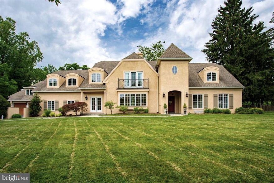 Exceptionally beautiful custom built 2004 French Country inspired house designed by architect Rene Hoffman  on 1.3 acres with the appeal of a small walled preserve.   Delightful gracious scale, light, and quality finish throughout where you'll find the best of open concept design combined with a conventional plan.  Front entry porch with slate floor.  Two story entry hall has a lovely stair with tall window on base landing,  very pretty hall powder room.   Living room with gas fireplace, open to dining room with glass doors to front walk.  A true great room is the heart of the house and is a fantastic space where center island kitchen is open to a huge dining area and family room  with gas fireplace and glass doors to awesome patio with stone fireplace and pergola.   Custom kitchen with beautiful cabinetry, quartz counters, subway tile walls,  Thermador gas range with exhaust hood,  big Viking refrigerator/freezer,  GE Monogram double door wall and  convection microwave ovens,  2 Thermador dishwashers, 2 sinks.    A hall to front dining room has a big pantry closet, counter/cabinet/serving+bar area with sink.  Off the kitchen is a gracious,  great looking rear hall  with  back stair, mudroom area with 2 built-in storage benches, terrific brick tile floor, glass door to small porch  to detached garage and driveway.  Big, bright rear hall  laundry room with sink.   Off the rear hall is a 2nd family room/game room/gym with slate floor, pellet stove,  big storage closets.   A bedroom suite  on the other side of the first floor from the entry hall could be the primary bedroom suite: an expansive bedroom space with large window seat flanked by 2 closets; luxury scale bath with big double vanity sink/oval tub/stall shower and a glass door to back patio;  great front sitting room/office.  The second floor hallway is a big  open sitting room space.  Double doors to a primary bedroom with a right hall area with walk-in closet and 2nd closet;  left hall with walk-in storage closet leading to  fantastic spa-like primary tile bath with gas fireplace, oval tub, stall shower, big double vanity sink.  3rd bedroom is another large  suite with walk-in closet , custom wall shelf,  and white marble tile bath with oval sink/chrome base, shower over tub.  The 4th bedroom with large front windows and glass door has a  custom wall shelf and closet to a captivating playroom hideaway with oval window and light well to  hall.  This bedroom has entry to the expansive hall tile bath with 2 pedestal sinks and shower over tub, window niche.  Big 5th Bedroom with wood wainscot and large walk-in closet.    Large second floor laundry room with sink.  The back second floor hall has a window niche, closet, and back stair to first floor.  The expansive basement  with glass doors to steps to side yard  is  original to the 1959 house this house is built on.  The detached 2 car garage is oversized; inside a wide wood stair (with a side entry ) leads to a terrific large finished recreation room (approx. 24 x 24) with high peaked ceiling, wood floor,  great looking dry bar, wine fridge,  portable rolling AC window unit, pellet stove, storage closet.  Note the seller's detailed upgrade and improvement list with the disclosure.  The well planted grounds  with beautiful trees and shrubs offer plenty of open  space for play and gardening.  Enjoy a deluxe patio for dining, relaxing, and just taking in the beautiful surrounding green space!  A fenced raised bed vegetable garden is behind the garage.  Inside and out, this property is a tranquil refuge in fantastic condition with a location minutes to everything.