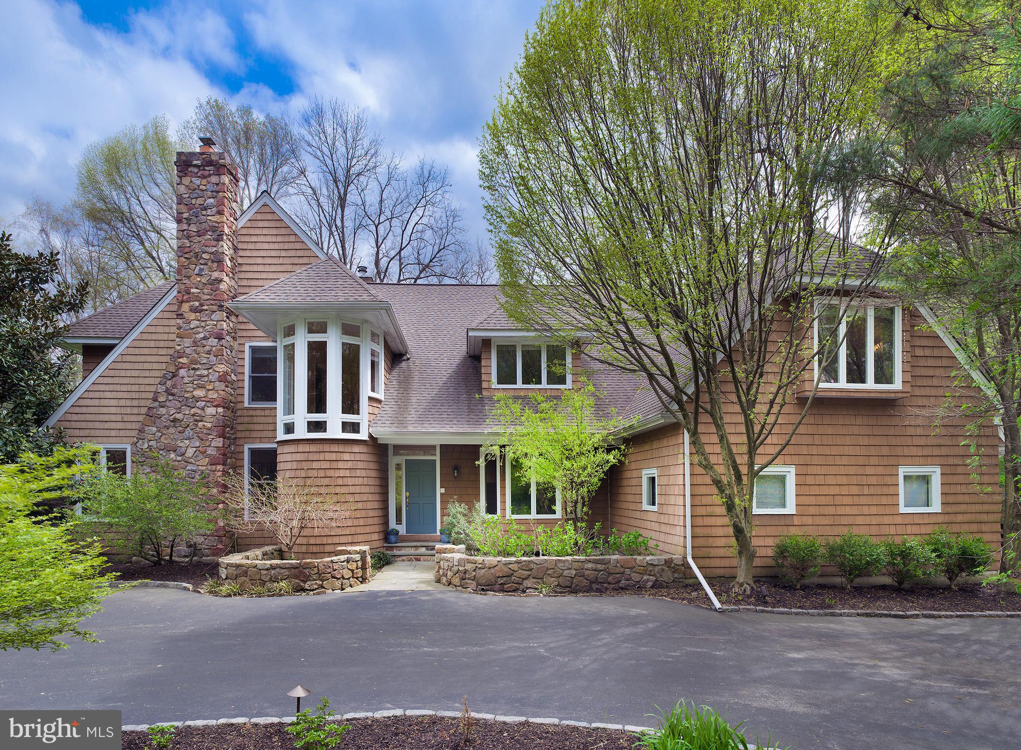 Enjoy coming home to this beautiful 4 bedroom, 4 and a half bath custom colonial on a private acre in prime Radnor Township, close to it all. Curb appeal catches your eye and impresses with distinctive architectural design, a striking cedar exterior, large motor court, and long drive that winds to a 3-car attached garage. In the rear awaits a spacious flagstone patio for summer family fun, alfresco dining, barbecues and entertaining. Your outdoor oasis is enhanced by lovely landscape lighting and hardscaping, a fire pit area, and lush greenery views. Sprawling lawn affords lots of play space for the kids and pets too! Elegant light-filled interiors welcome you with a gracious entry hall accented by grand pillars, tiled flooring, and a dramatic turned staircase. Airy 9+-foot ceilings and hardwood floors grace the first level featuring an open floorplan for hosting guests. Lounge and converse in the large sunny living room centered by a wood-burning fireplace, then step out to the flagstone patio through glass doors for easy indoor-outdoor living. Across the foyer is an inviting dining room for formal occasions and casual meals. Cook and hangout in comfort in the kitchen and family room, the heart of the house. Gather around the wood-burning fireplace, watch TV, movies & sports events, and serve cocktails from the convenient built-in wet bar with wine fridge while the chef prepares nearby. Sets of glass doors bring nature in and lead to the rear patio. A peninsula with seating connects the family room to the open kitchen plus is a great hors doeuvres station. Cooks quarters are finely-appointed with granite countertops, abundant cabinet storage, and new stainless steel appliances including a built-in Miele oven & coffee maker. Have a cup of Joe and a snack in the breakfast area with picturesque backyard views and a door to the patio. A very handsome cherry-paneled office/library provides a quiet place to work and patio access. A powder room, updated mudroom and rear staircase off the kitchen complete the main level. Upstairs, a bright open landing introduces the sleeping quarters. The expansive primary bedroom offers a dressing area, 2 walk-in closets, and a marble spa-like bath with radiant heat floors, a sunken tub and steam shower. Two additional well-proportioned bedroom suites sit down the hall; and another bedroom with bath near the back staircase is like a private haven, for long-term visitors or a perfect au-pair/in-law suite. Other highlights are fresh paint, central vacuum, central air, a security system, unfinished basement and whole-house generator. There is even more to love being in close proximity to dining, shopping, the train station, major highways, and award-winning Radnor schools!