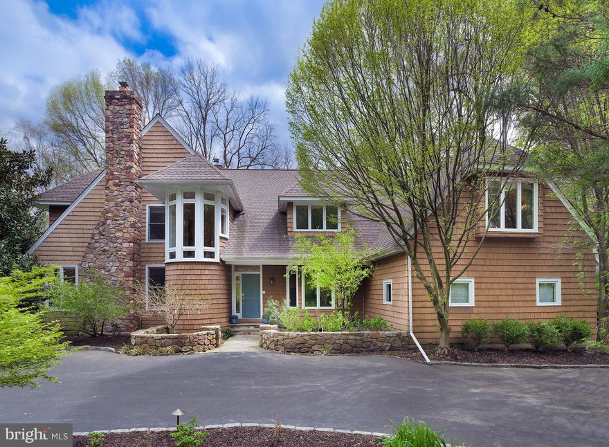 Enjoy coming home to this beautiful 4 bedroom, 4 and a half bath custom colonial on a private acre in prime Radnor Township, close to it all. Curb appeal catches your eye and impresses with distinctive architectural design, a striking cedar exterior, large motor court, and long drive that winds to a 3-car attached garage. In the rear awaits a spacious flagstone patio for summer family fun, alfresco dining, barbecues and entertaining. Your outdoor oasis is enhanced by lovely landscape lighting and hardscaping, a fire pit area, and lush greenery views. Sprawling lawn affords lots of play space for the kids and pets too!  Elegant light-filled interiors welcome you with a gracious entry hall accented by grand pillars, tiled flooring, and a dramatic turned staircase. Airy 9+-foot ceilings and hardwood floors grace the first level featuring an open floorplan for hosting guests. Lounge and converse in the large sunny living room centered by a wood-burning fireplace, then step out to the flagstone patio through glass doors for easy indoor-outdoor living. Across the foyer is an inviting dining room for formal occasions and casual meals.   Cook and hangout in comfort in the kitchen and family room, the heart of the house. Gather around the wood-burning fireplace, watch TV, movies & sports events, and serve cocktails from the convenient built-in wet bar with wine fridge while the chef prepares nearby. Sets of glass doors bring nature in and lead to the rear patio. A peninsula with seating connects the family room to the open kitchen plus is a great hors doeuvres station. Cooks quarters are finely-appointed with granite countertops, abundant cabinet storage, and new stainless steel appliances including a built-in Miele oven & coffee maker. Have a cup of Joe and a snack in the breakfast area with picturesque backyard views and a door to the patio. A very handsome cherry-paneled office/library provides a quiet place to work and patio access. A powder room, updated mudroom and rear staircase off the kitchen complete the main level.  Upstairs, a bright open landing introduces the sleeping quarters. The expansive primary bedroom offers a dressing area, 2 walk-in closets, and a marble spa-like bath with radiant heat floors, a sunken tub and steam shower. Two additional well-proportioned bedroom suites sit down the hall; and another bedroom with bath near the back staircase is like a private haven, for long-term visitors or a perfect au-pair/in-law suite. Other highlights are fresh paint, central vacuum, central air, a security system, unfinished basement and whole-house generator. There is even more to love being in close proximity to dining, shopping, the train station, major highways, and award-winning Radnor schools!