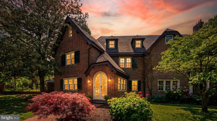 Prepare to fall in love with this rarely available, five-bedroom, all-brick, Tudor corner townhome. Tucked away in the sought-after Guilford neighborhood, this home offers a serene setting while remaining conveniently located near the best that Baltimore has to offer. Built in 1915 by Edward L. Palmer Jr., the exterior showcases traditional Tudor half-timbering with elegant Flemish bond and herringbone brickwork, alongside an oversized chimney and a steeply pedimented Craftsman entryway.  

The Welcome: Enter through a charming, brick archway that serves beautifully as a sun-drenched mudroom and sunroom. Step across the threshold onto gorgeous oak hardwood floors into a sprawling living room centered around a cozy brick, wood-burning fireplace. Throughout the home, you will find historic details like original sconces, doors, doorknobs, and stained wood windows.  

The Chef's Kitchen: The heart of the main floor underwent a stunning full remodel in 2025. It features sleek shaker cabinets, gas cooking, a stylish tile backsplash, and sparkling quartz countertops installed in 2021. Step from the kitchen onto a premium composite deck (2022) and a private rear yard. It is an idyllic, urban retreat crafted for al fresco entertaining, gardening, or relaxing with a morning coffee. 

Main Floor Convenience: A cleverly positioned half-bathroom featuring rustic exposed brick completes the main living level.

The Upper Floors: Venturing upstairs to the second level, you will discover the spacious master bedroom and two additional bedrooms. A generous, full bathroom completes this level. The delightful third floor has fourth and fifth bedrooms that include built-in shelving and angled ceilings, and a checkered-tile bathroom. 

The basement is a versatile space that includes laundry, a workbench for DIY projects, storage, and convenient walk-up stairs leading to the rear of yard.

While preserving its historic soul, the home functions with entirely modern efficiency: The radiator boiler was fully replaced, providing cozy winter warmth (2023). Complete peace of mind with a fully replaced, high-efficiency HVAC system (2025) for the second and third floors alongside a serviced mini-split system on the first floor (2025).

Delight in one of Baltimore’s most beautiful neighborhoods. With its lush tree canopy to its charming sidewalks, this gem is a true retreat tucked in the city. Enjoy convenient and ample street parking, all within walking distance from Sherwood Gardens, Charles Village shops and restaurants, the Waverly Farmer’s Market and Public Library, the BMA, Hopkins, and Loyola. Welcome home to 407 Bretton Place!