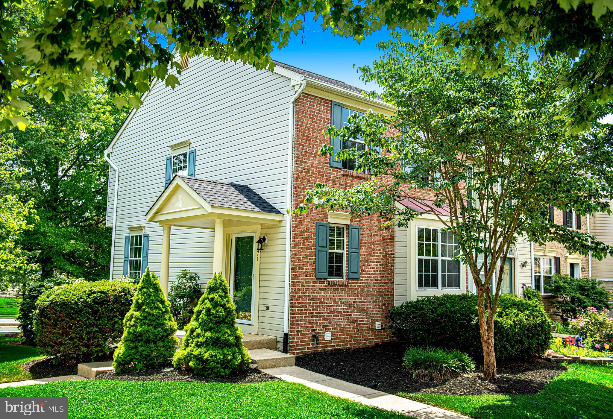 Beautifully updated brick-front end-of-group townhouse with 3 bedrooms, 2 full & 2 half baths. This move-in-ready home features recent updates including a new roof, fresh neutral interior paint, luxury vinyl plank flooring on the main level and in the upper-level bathrooms, new carpet, landscaping, updated vanities (3 of 4) and toilets, as well as some light fixtures and mirrors (all 6/2025). Water heater 6/2024. The covered side entry opens into a welcoming foyer that leads to a bright kitchen equipped with a center island, stainless steel appliances, a pantry, and ample cabinet space. The open-concept dining and living area is spacious and filled with natural light, offering plenty of room for gatherings and enhanced by chair rail detailing. Upstairs, the spacious primary bedroom offers generous closet space and an updated en-suite bathroom. Two additional well-sized bedrooms share a refreshed hall bath. The fully finished lower level includes a spacious family/rec room with sliding glass doors to the backyard, a separate laundry room with utility sink, and an additional half bath. The recently landscaped backyard provides an outdoor space for relaxation or entertaining. Parking includes two dedicated spaces, guest parking, and ample street parking. Desirable location is close to restaurants, schools, shopping, commuter routes and more.