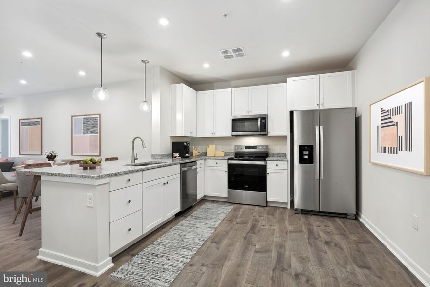 NEW CONSTRUCTION / 55+ COMMUNITY Special all-in price! Aspen home for immediate delivery. This 3rd-floor home has two bedrooms and is only steps away from the building's elevator. Enjoy a little rest & relaxation while you watch the sunset from your private balcony. Your luxurious primary suite offers comfort, featuring dual closets and plenty of space to make it your own by adding a desk for your workspace or even creating a sitting area to enjoy your favorite book during your downtime. Relish the tranquility you deserve in this inviting home. Highlights: separate storage unit, designer flooring throughout the main living areas, an electric fireplace in the living room, and included blinds on all windows. Gatherings® at Potomac Station is just minutes from Historic Downtown Leesburg - enjoy brand-new condos close to shopping & dining! *Secure a 5.99% Interest Rate with a Choice Lender on SELECT homes, now through 2/19.* (See Community Manager for details) **Photos are of a similar completed home. (Additional restrictions may apply. See New Home Counselor for complete details.) Look for parking along California Avenue near the paved steps/ramp between the main buildings. Follow the signs and take the steps or ramp to our building entrance. Please use keypad to call our 2nd-floor MODEL SALES OFFICE.