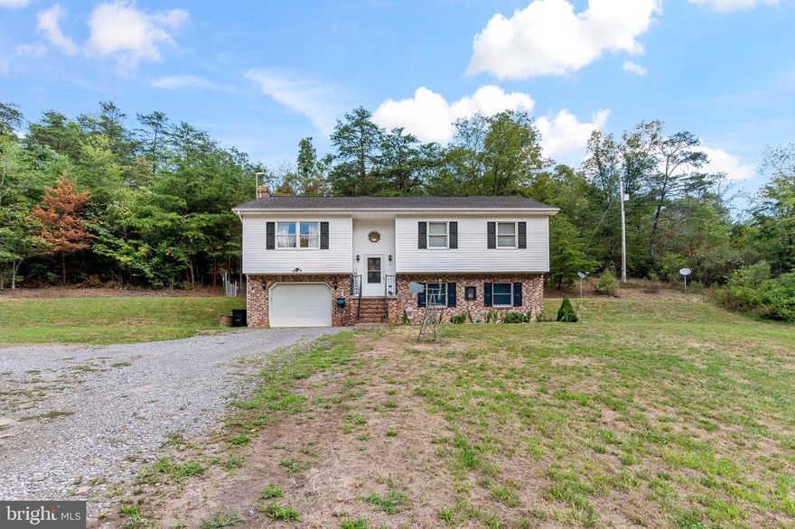 Very nice home situated on 2 unrestricted acres, that's right no restrictions!  Beautiful laminate flooring, cathedral ceiling, stainless steel appliances and much more.  Make this your starter home or your get away.  Split level, with 2 bedrooms and 2 baths on the main level, with an additional bedroom with half bath on lower level.  Or if no need for 3rd bedroom, make that your entertaining room, game room, craft room or a man cave...Many ways to use this spacious space.  With this property, it is an easy commute to interstate 70 or 68 for work. Check it out now...