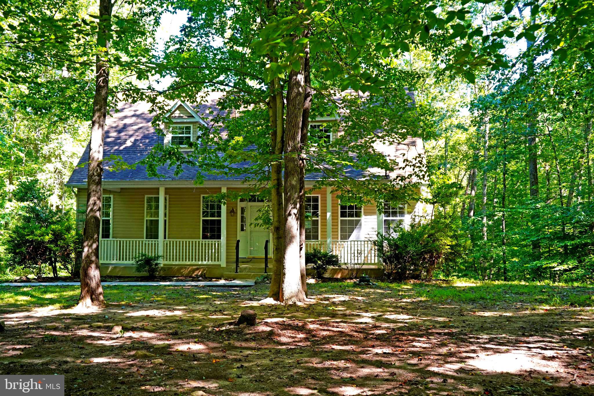 Beautiful back to nature setting surrounds this charming Cape Cod. Five acres of wooded seclusion, you can't even see a neighbor. Sit on your front porch and watch the birds, squirrls and deer pass by. There's even a lilly pad pond out back. Trails to walk. Open areas for parking campers, boats or other toys. Inside you'll find an open floorplan with an owners suite on the first level, full bath and walk in closet. A large laundry room/pantry is located off the main floor hallway. The upper level is spaced out for two bedrooms,
One is set up with a full bath the third was left open to use as an office or sitting room but can easily be converted back to bedroom status by framing in the doorway. There's a full unfinished basement with the complete rough in for a full bath. That gives you endless opportunities to finish it off as you'd like, additional bedrooms, family room, game room, whatever. Don't miss this opportunity to own your 5 acre wooded wonderland.