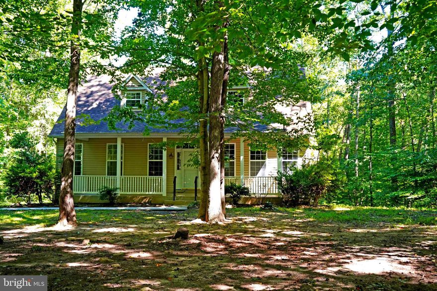 Beautiful back to nature setting surrounds this charming Cape Cod.  Five acres of wooded seclusion, you can't even see a neighbor.  Sit on your front porch and watch the birds, squirrls and deer pass by.  There's even a lilly pad pond out back.  Trails to walk. Open areas for parking campers, boats or other toys.  Inside you'll find an open floorplan with an owners suite on the first level, full bath and walk in closet. A large laundry room/pantry is located off the main floor hallway.  The upper level is spaced out for two bedrooms,
One is set up  with a full bath the third was left open to use as an office or sitting room but can easily be converted back to bedroom status  by framing in the doorway.  There's a full unfinished basement with the complete rough in for a full bath. That gives you endless opportunities to finish it off as you'd like, additional bedrooms, family room, game room, whatever.  Don't miss this opportunity to own your 5 acre wooded wonderland.