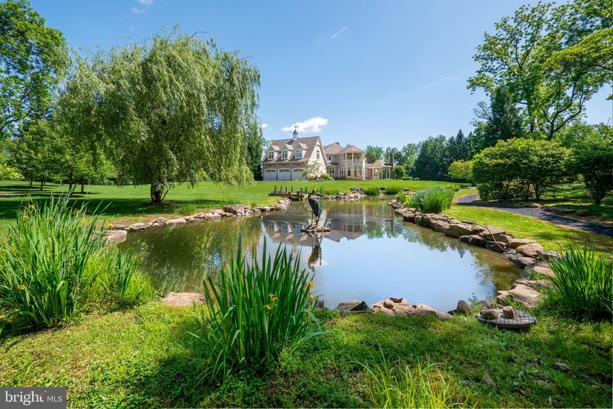 Nestled at the end of a tranquil drive, this EXQUISITE ESTATE sprawls across 4.13 acres of picturesque park-like grounds, tempting exploration along WHITE ACRE's exclusive private roads. This beautiful home is enhanced with MULTIPLE TERRACES, DECKS, and PORCHES, each offering panoramic vistas of the verdant lawn, a lovely PRIVATE GARDEN, and a serene POND adorned with a captivating stone WATERFALL and charming dock. An enchanting WALKING PATH circles the property inviting one to enjoy the out-of-doors. As you approach along the CIRCULAR DRIVE, the welcoming facade commands attention, evoking an inviting sense of timeless GRACE and REFINEMENT. Majestic pillars, a lustrous mahogany porch floor, and a grand entrance offer a glimpse into the luxuries within. Every facet of this remarkable residence showcases IMPECCABLE CRAFTSMANSHIP and FINE MATERIALS, seamlessly fusing timeless elegance with the convenience and innovation of modern bespoke construction. Adding to the unwavering attention to detail, lavish luxuries include a lower level THEATER, FITNESS ROOM, aromatherapy STEAM SHOWER, and spectacular HEATED SALTWATER POOL with SPA. A welcoming and well-appointed second level GUEST SUITE offers privacy and convenience with a KITCHENETTE and separate bedroom. Meticulously maintained, 1710 White Acre is the epitome of REFINED LIVING and awaits an owner who values unparalleled QUALITY. Discover the pinnacle of luxury living in SAUCON VALLEY, where this property reigns supreme.