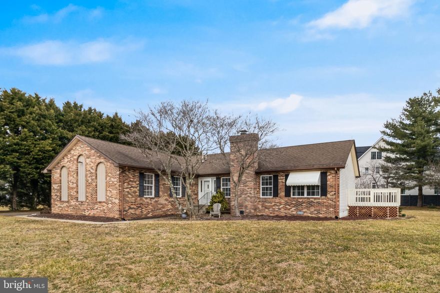 Located in desirable Broomes Island, this one-level brick front rambler offers seasonal views of Island Creek and a peaceful setting surrounded by mature trees. A tree-lined driveway leads to the side-load garage, creating a welcoming first impression. Inside, a spacious foyer opens to the living and dining room with vaulted ceilings, creating an airy feel throughout the main living space. The living room features a wood burning fireplace and flows easily into the dining area, where french doors lead to a sunroom and deck, perfect for enjoying beautiful sunset views over the creek. The kitchen offers ample counter space, a pantry, room for a table, and a newer dishwasher. A split-bedroom floor plan provides privacy, with the oversized owner’s suite situated on one side of the home. The suite includes its own linen closet and a bathroom with double vanity. Two additional bedrooms and a full bath are located on the opposite side of the home. The laundry and mudroom combination offers the perfect drop zone for outdoor gear and convenient access for everyday chores. Outside, enjoy a flat, usable backyard with a privacy fence, ideal for outdoor activities. Additional updates and features include a whole house generator, hot water heater replaced in 2021, and a dryer replaced in 2024.