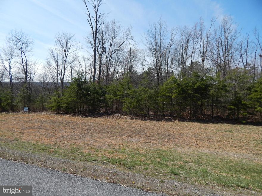 SPRING SALE!! 1.011 AC in Prestigious Cacapon South. Featuring paved roads & mt. views, this is the perfect location for full time or weekend retreat. Across the street from 6115 Ac State Park featuring golf+swimming+paddle boats+horseback riding+skeet shooting+playground+tennis+basketball+volleyball+restaurant Located 10 M South of Berkeley Springs & w/in 20 M of Winchester, VA for easy commuting