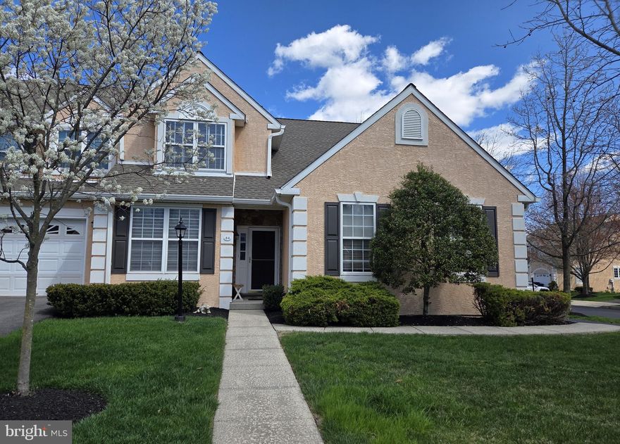 Welcome to Wheatsheaf Village a townhouse community of 54 home in clusters of three located in Worcester Township.    This is the three bedroom end unit with a first floor owner's suite and a two car garage you have been looking for.     Upon entry into the foyer you are greeted with hardwood floors that flow into the kitchen and the large open living room and dining room.    The open floor plan on the first floor includes a large open living room - dining area with hardwood floors and a vaulted ceiling that makes area feel larger than it already is.  The living room has a gas fireplace, large sliding door to a deck and custom window treatments that allow light to shine thru.  The dining area has hardwood floors, large windows with custom window treatments.   The kitchen has new appliances and plenty of cabinet and counter top spaced.  The first floor owner's suite and bath include a walk in closet, large corner soaking tub, double bowl vanity,  shower stall and private water closet.  There is a den or office, half bath and first floor laundry.  The second floor has two spacious bedrooms one with a walk-in closet and a full bath.  There is a two car attached garage  and large driveway for guests and full unfinished basement is perfect for storage and can be finished for additional living space.  Major improvements are complete, the roof (by the HOA), gutters and downspouts were replaced in 2021, stucco in 2024, heating and air conditioning in 2022.   The community is in walking distance to a park for a playground, it's convenient to shopping, restaurants and major traffic major traffic arteries.  The HOA includes the roof replacement not the repairs, lawn care, mulch, shrub trimming, snow removal from the street and service walk, the homeowner is responsible for the snow removal from the service walk to the front door and driveway.  Washer and Dryer and refrigerator included in "AS IS".