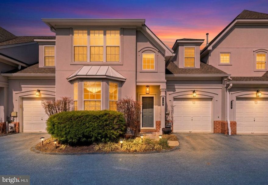 Welcome to luxury, convenience, and low-maintenance living in the highly sought-after Grey Rock Villas, a premier gated community in the heart of Pikesville.

This stunning two-level condo is designed to impress, featuring a rare main-level primary suite and a dramatic two-story family room filled with natural light and anchored by a cozy fireplace. From the moment you step inside, you’ll notice the rich hardwood floors, soaring ceilings, and thoughtfully designed open-concept layout that lives like a single-family home.

The gourmet kitchen is equipped with granite countertops, stainless steel appliances with gas cooking, 42” soft-close cabinetry, and a spacious pantry, seamlessly flowing into a bright breakfast nook—perfect for everyday living. Entertain with ease in the elegant dining room accented with crown molding, or unwind in the expansive living space with direct access to your private brick patio.

The main-level primary suite offers the ideal retreat, complete with a large walk-in closet and a spa-like bath featuring a soaking tub, dual vanity, and separate shower.

Upstairs, you’ll find a versatile loft overlooking the main living area, along with two generously sized bedrooms, a full bath, and a flexible bonus room perfect for a home office, gym, or additional storage.

Additional highlights include a 1-car garage, main-level laundry, custom window treatments, and a home that truly shows like a model.

Enjoy a carefree lifestyle with no exterior maintenance , plus access to community amenities including a pool and putting green all within a secure gated setting.

Ideally located just minutes from Woodholme Center, shopping, dining, and major commuter routes including I-695, I-795, and Reisterstown Road, this home offers the perfect blend of luxury and convenience.

Opportunities like this don’t come often—schedule your private tour today.