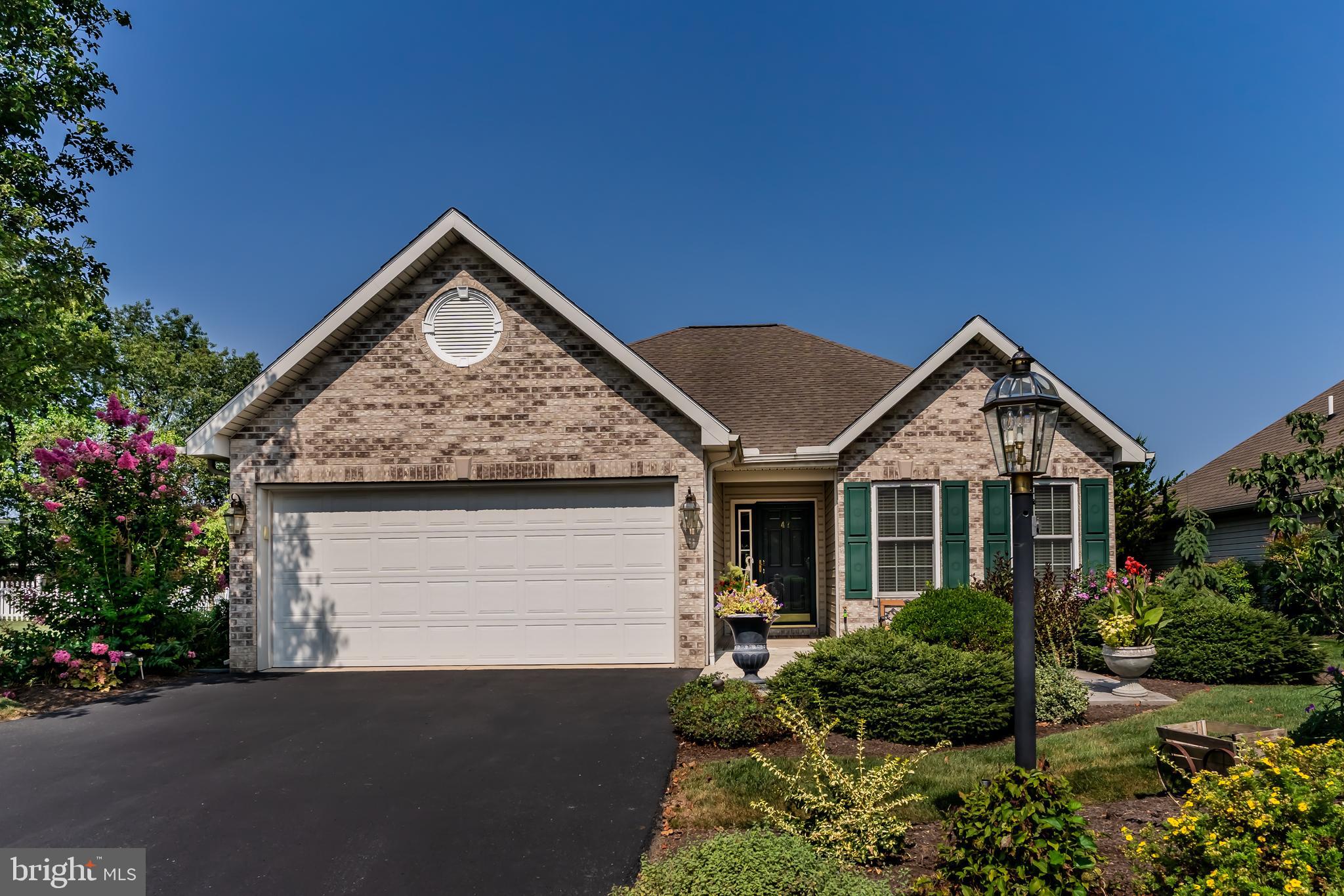 Whether you’re just starting out, starting over, or downsizing, this meticulously maintained rancher is a must-see. From the moment you arrive, the vibrant landscaping welcomes you with bursts of color and a sense of privacy that’s hard to find. Inside, a smart, open floor plan seamlessly connects the kitchen and family room—perfect for both everyday living and entertaining. The expanded dining area is surrounded by beautiful full length windows showcasing garden views. Your kitchen boasts abundant cabinet space, generous counters, and a timeless ceramic tile floor that’s both elegant and easy to maintain. Just steps away, a custom bar with cabinets & wine fridge doubles beautifully as a coffee station or cocktail hub. The family room feels airy and bright with vaulted ceilings, an abundance of windows, gleaming hardwood floors, and a cozy fireplace for cool evenings. From here, sliding doors open to a versatile screen and insulated glass sunporch—ideal for casual gatherings, happy hours or al fresco dining. Your primary suite offers a spacious bedroom, a large walk-in closet, and a well-appointed bath with dual sinks, a low-threshold walk-in shower, and thoughtful finishes. In-ceiling speakers with individual room controls let you enjoy your favorite music or entertainment in every corner of the home. Additional highlights include a spacious guest suite, another full bath and a large floored attic, accessible from the 2-car garage, providing all the storage you’ll ever need. This home is even plumbed for a Central Vac system with multiple ports. You won't want to miss this one! Schedule your private tour today!