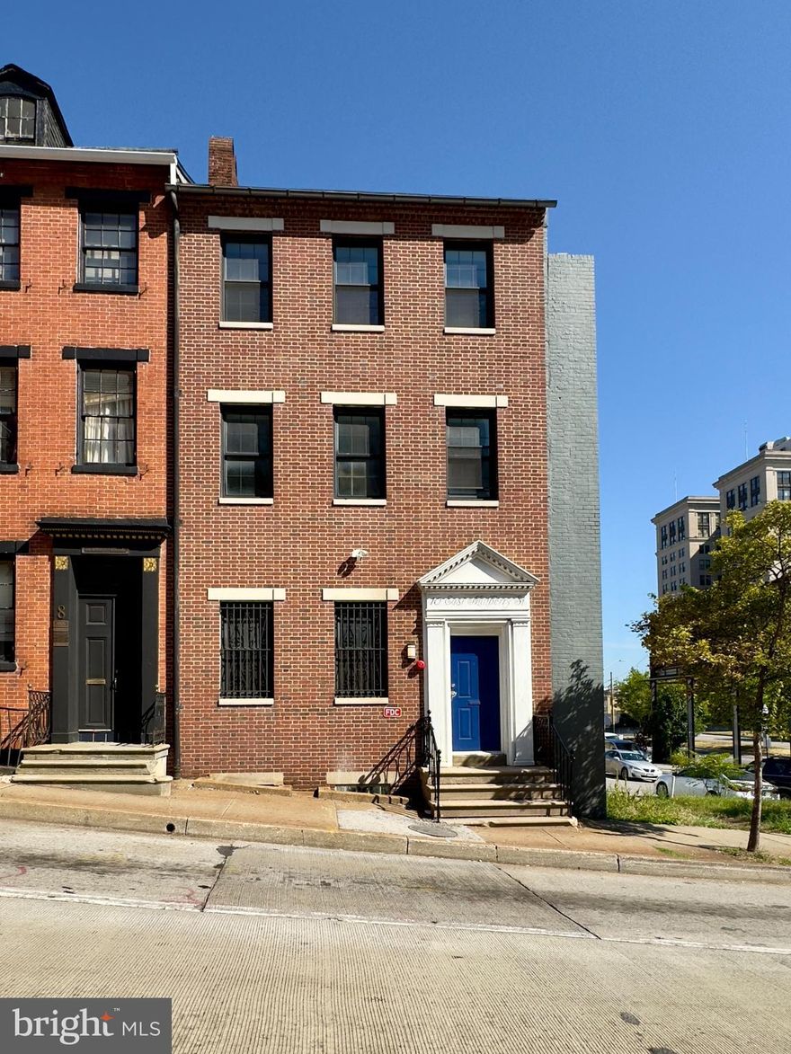 This thoughtfully designed studio apartment offers a refined city living experience within a historic end-row brick townhouse in the heart of Baltimore. Located in the rear portion of the property, this unit combines modern finishes with timeless architectural elements to deliver both character and functionality.

The main studio area features wood flooring, high ceilings, and a striking exposed brick accent wall that adds texture and visual interest. Full-length windows along one side of the room provide generous natural light, creating an open and airy feel throughout the space. A neutral color palette and abundant electrical outlets allow for easy customization and versatility. A built-in closet offers storage without compromising the living area.

The kitchen is outfitted with stainless steel appliances including a microwave, stove with oven, dishwasher, and refrigerator. Built-in cabinetry provides ample storage. The kitchen also features wood flooring and a window that brings in natural light and ventilation.

The bathroom is finished with tiled flooring and a walk-in tiled shower. A wide lavatory, vanity mirror, cabinet storage, and drawers contribute to a clean and efficient design that supports daily comfort.

This unit is equipped with an in-unit washer and dryer, access to 24-hour emergency maintenance, and an online tenant portal for added convenience.

Pets under 40 pounds are welcome with a signed pet addendum and a $500 non-refundable pet fee.

Situated near key academic institutions, business districts, and cultural landmarks, this location is ideal for those seeking a professional, low-maintenance living space within easy reach of downtown Baltimore's top destinations. Pay parking is available at the side of the building.

Nearby Attractions and Highways

Walters Art Museum – 3 minutes

Lexington Market – 4 minutes

Inner Harbor – 5 minutes

Camden Yards – 7 minutes

Maryland Science Center – 6 minutes

I 83 – 2 minutes

I 95 – 5 minutes

Pets under 40lbs are welcome with a pet addendum and a $500 non-refundable pet fee.

The monthly water bill will be evenly split between occupied units.

Agency disclosed upon initial contact. Agent conducts showings; BMG manages follow-up, paperwork, move-in post-approval. Vouchers work with BMG directly.