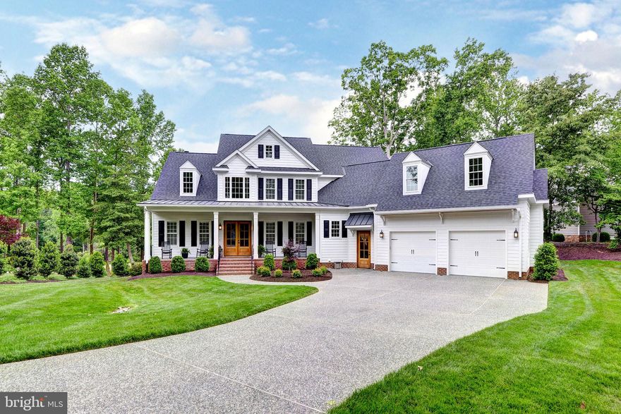 Welcome to your new custom dream home on the 5th hole of the famed Blue Heron course in Ford’s Colony, Williamsburg’s premier gated golf community. This stunning white modern farmhouse features soaring 10' ceilings, a chef’s kitchen with stainless steel Wolf range, dual ovens & dishwashers, and extra wide built-in refrigeration columns. Entertain with ease in the Keeping Room with custom bar, Sonos sound system, and a screened Trex porch with stone fireplace. The spa-like primary suite boasts dual vanities, soaking tub, and a huge luxury tiled shower. Every bedroom offers an en-suite bath and huge closet. Custom trim throughout, two laundry rooms, mudroom with cubbies off spacious garage, and luxury finishes throughout make this home as functional as it is breathtaking.