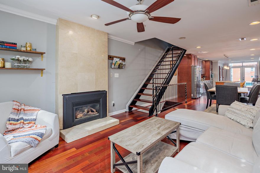 Stunning Federal Hill Rowhome with Harbor Views and Rooftop Oasis! Discover urban luxury at its finest in this impeccably renovated Federal Hill rowhome, boasting over 2,500 sq. ft. of living space, private parking, and an expansive rooftop deck offering unparalleled views of Baltimore's picturesque harbor. Step inside to find a seamless blend of historic charm and modern elegance, highlighted by hardwood floors, exposed brick accents, and crown molding throughout. The open floor plan effortlessly connects a spacious living room and dining area, perfect for entertaining. The gourmet kitchen is a chef's dream, featuring a central island, granite countertops, stainless steel appliances including a wine fridge, and a sunny breakfast area. On the second level there are two generously sized bedrooms, a full laundry area, and a newly remodeled full bathroom. This level is perfect for having a home office, guest room, or living area on the second floot. Upstairs, the entire third floor is dedicated to a luxurious master suite. There is a large living area and sleeping area with high ceilings and beautiful hardwood floors and exposed brick. Enjoy the privacy of a walk-in closet complete with custom built-ins, and indulge in spa-like relaxation in the en-suite bathroom with dual vanities, a soaking tub, and an oversized rainfall shower with body sprays. Additional highlights include a convenient wet bar, a finished basement with a full bath, and a tankless water heater ensuring comfort and efficiency. Off of the master level there is a two tier rooftop deck offering unbelievable views of the Baltimore harbor! Perfect for dinig and relxing or entertaining guests. Located in the heart of Federal Hill, this home offers easy access to everything that the city has to offer. Steps from Riverside Park as well as some of the best dining and shopping in the city.  Conveniently located within 5 minutes of grocery stores, shopping, dining, and several gyms! Don't miss the opportunity to own this extraordinary property that combines luxury, comfort, and breathtaking views in one of Baltimore's most coveted neighborhoods. This property is one of a kind, and you won't find more value for the price!
