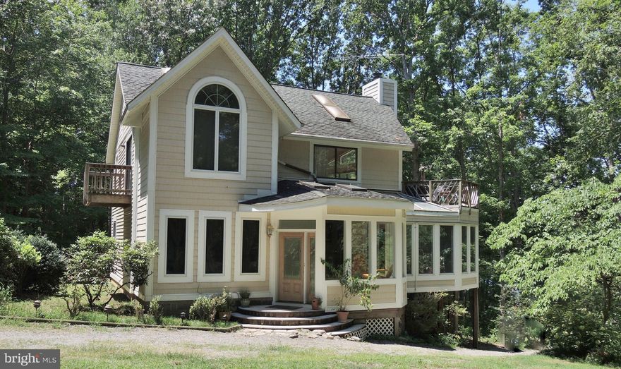 Fabulous home right on Lake Anna perfect for year-round fun*Custom contemporary home on the water on a 1+ acre private site on a quiet cul de sac*Privacy & lake views from walls of windows in the home*New carpet/painted*Decks*Circular driveway*Updated*2-story boat house/dock with a covered porch & upper/lower sun decks*Covered boat slip*MOTIVATED SELLER!