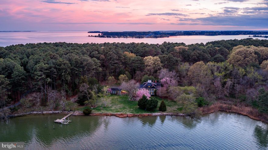 Offered for the first time in over 50 years, this 13+/- acre waterfront property on Broad Creek presents a
rare opportunity to own an expansive estate with exceptional shoreline frontage. With more than
960+/- feet of waterfront, the setting provides unobstructed water views and a private pier, offering
direct access to the creek and surrounding natural landscape. A tree-lined private driveway leads to the
residence, positioned to take full advantage of its waterfront location. The home features 6 bedrooms and 4 full/1 half baths. The main level includes a screened-in porch entry, welcoming foyer, spacious living room with fireplace, formal dining room with a second fireplace, and a flexible study or office with built-in shelving and water views. The updated eat-in kitchen is equipped with granite countertops, a large
breakfast bar, gas cooktop, stainless steel appliances, and a spacious pantry. A main-level half bath completes the floor. Both a primary staircase and a secondary staircase provide access to the upper levels. All six bedrooms are located on the second floor. The owner’s suite includes a fireplace, ensuite bath, and access to a front-facing balcony. Front-facing secondary bedrooms also have balcony access. The third level offers additional living space, including a large bonus room, entertainment room, three additional rooms, completed drywall and electrical work, and a full bath with shower. Additional property features include a detached garage with parking and storage, an externally accessed basement for storage, a
wide exterior pad suitable for boat or RV storage, hardwood floors, a waterside deck, and a private pier. This property combines acreage, extensive waterfront frontage, and a spacious residence ready for its next owner.