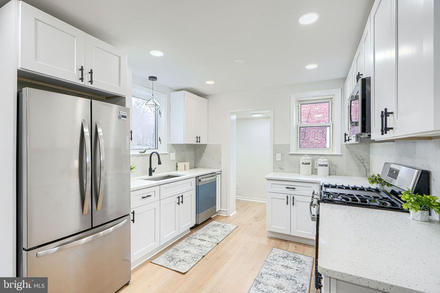 Welcome to 8702 Maravos Lane in Parkville, a beautifully renovated detached home offering the perfect blend of space, style, and functionality. This spacious residence features 5 bedrooms and 3 full bathrooms, thoughtfully updated throughout. Enjoy a bright and inviting main level showcasing new flooring, recessed lighting, abundant natural light, and a cozy fireplace. The brand-new kitchen is a standout, complete with white shaker cabinetry, stainless steel appliances, and modern finishes. The main level also includes 2 bedrooms, a full bathroom, and a versatile bonus room surrounded by windows—ideal for a den, playroom, or sunroom. Upstairs, retreat to the private primary suite featuring a generously sized bedroom, ample closet space, and a large en-suite bathroom. The fully finished basement expands your living space with 2 additional bedrooms, a full bathroom, and a spacious recreation area—perfect for entertaining, guests, or multi-generational living. Outside, enjoy a large driveway and beautifully maintained landscaping that enhances the home’s curb appeal. Move-in ready and thoughtfully updated—this is one you won’t want to miss!