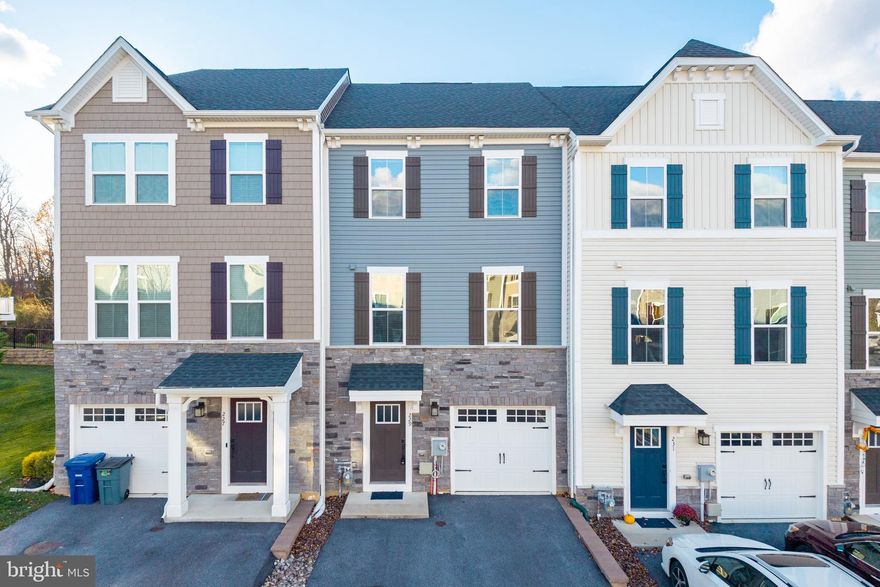 This impeccably maintained, nearly new townhome in the coveted Downingtown School District blends modern luxury with exceptional convenience. The entry level welcomes you with a versatile bedroom suite featuring a walk-in closet and full bath—an ideal private guest space or an elegant walkout rec room opening to the tranquil backyard. The main level exudes sophistication with continuous hardwood floors and a gourmet kitchen showcasing stainless steel appliances, an expansive island with seating, a generous pantry, and custom open shelving, all flowing seamlessly into a stylish eat-in area with sliders to the deck—perfect for refined entertaining. Adjacent is a spacious, sun-filled family room designed for effortless living. The upper level hosts a luxurious Primary Suite accented by tray ceilings, a large walk-in closet, and a spa-inspired en-suite bath with dual vanities, modern finishes, a soaking tub, and a separate glass-enclosed shower. Two additional well-appointed bedrooms, a beautifully finished full bath, and a convenient laundry room complete this level. Situated minutes from premier shopping and dining, this 4-year-old residence has also been pre-inspected, offering both elegance and peace of mind to the future homeowner. The Spotlight Home Inspection report is available upon request.  Attend an Open House or schedule a private tour today!
