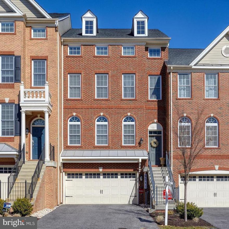 Large Luxury 4 Level Brick Townhome with 2 Car Garage. Beautiful Hardwood Floors throughout  Main Level with a Spacious Living Room and Formal Dining Room  featuring Crown Molding and Chair Railing.  Kitchen with Large Island offering plenty of seating opening to a Family Room featuring a Gas Fireplace making it a perfect place for Get Togethers with Family and Friends.  Spacious Lower Level with a Full Bathroom and Slider to walkout to the rear yard.  Owner's Suite offers enough space for a Sitting Area, has 2 Walk-In Closets and it's own Private Bathroom with a Soaking Tub and a Separate Shower.  Two additional spacious bedrooms and the Laundry is conveniently located in the hallway.  Enormous 4th Level Loft  Perfect for a Man Cave / Office / Guest or Game Room.  So much space and storage offered in the elegant Home.  Convenient Commuter location near I-295 / Route 32 & I-97.  Less than 10 minutes to Fort Mead and the MARC Train Station in Odenton & close to Shopping.