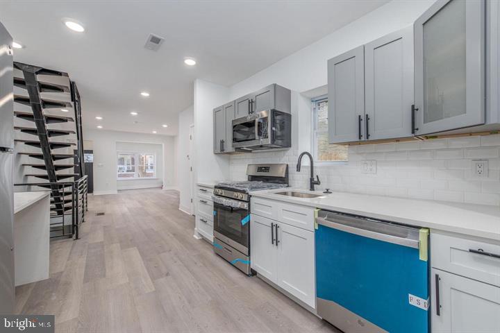 This beautifully updated townhome sits on a charming, tree-lined street and offers a perfect blend of modern upgrades and classic design. Step inside through the enclosed, finished porch with a convenient mudroom, leading into a spacious open-concept living and dining area. The home features elegant custom vinyl wood flooring and LED recessed lighting throughout.
The kitchen is a chef’s dream, boasting custom quartz countertops, ample cabinet and counter space, and brand-new stainless steel appliances. From here, step outside to a large, newly renovated backyard, perfect for outdoor gatherings.
Downstairs, the fully finished basement impresses with high ceilings, a nicely sized powder room, and updated interior sewer lines. Comfort is ensured year-round with a brand-new central air system and heating unit, along with upgraded electrical wiring.
Upstairs, a wide, open staircase with custom iron railings leads to three generously sized bedrooms, each with ample closet space. The second floor also features new vinyl hardwood flooring and a beautifully designed custom-tiled bathroom.
Additional highlights include brand-new windows, modern LED lighting, and easy street parking. Conveniently located with quick access to NJ bridges, I-95, and the Schuylkill Expressway, this home is truly move-in ready and offers everything you need for comfortable city living.