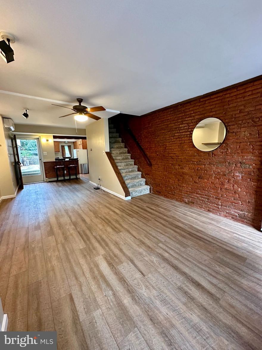 Step inside 112 W 1st Avenue, a charming row home located in the heart of downtown Conshohocken. This interior home boasts ample space, with a living room featuring an exposed brick wall, a dining room, and an updated kitchen complete with new cabinets, flooring, granite counters, fixtures, and more! The rear yard is a true gem, with two different levels that lead directly to off-street parking, making it perfect for entertaining family and friends. On the second floor, you'll find a cozy bedroom and a full bathroom, while the third floor offers two additional bedrooms with ductless/mini-split for heating and cooling, just like the first and second floors. The partially finished basement provides additional space for ample storage, as well as a laundry area with a washer and dryer. This home is conveniently located within walking distance to downtown Conshohocken and Restaurant Row, as well as the train station, bike trail, and bus routes.