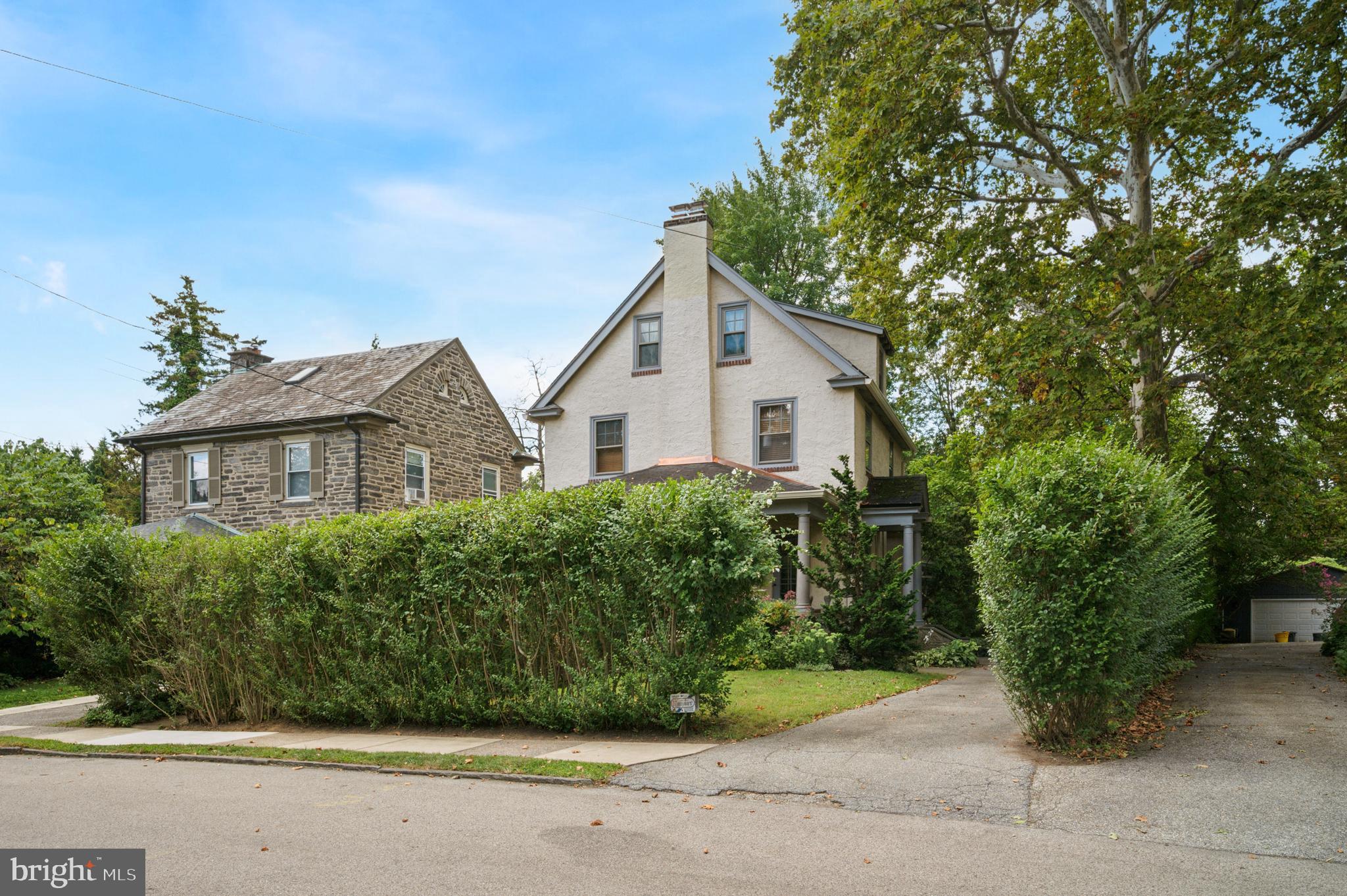 Welcome to 518 Merwyn Road!
This lovely, “move-in ready” Dutch Colonial home boasts 3+ bedrooms and 2 full baths. Located
on a quiet, tree-lined street just a short walk to the village of Narberth, its private driveway
leads to a covered front porch overlooking a secluded perennial flower garden with specimen
trees. The first floor offers an open floor plan with beautiful hardwood throughout. The original,
grand stone fireplace is the focal point of the expansive living room with two doors opening to
the front porch. A sublime, sunny formal dining room leads to a custom kitchen with abundant
wooden cabinets, gorgeous granite countertops, a built-in pantry, a granite-topped breakfast
bar with seating and a Jenn-Air electric stove, a KitchenAid double oven, and Bosch and Sub-
Zero appliances. Exit the kitchen or dining room to a large deck — perfect for grilling & relaxing — with
easy access to the long 4+ car driveway and the 2-car garage, complete with electricity. A charming curved stairway brings you to the second floor. The primary bedroom was converted from two bedrooms to make one spacious room with a wall of custom closets and decorative wood paneling. A generous second bedroom with walk-in closet and a modern hall bath with wainscotting, ceramic tile, pedestal sink, and glass-enclosed shower complete this floor. The third floor consists of two bedrooms, one currently used as a sitting room, and a delightful full bath with pedestal sink and the original clawfoot tub with added shower attachment. There is a full unfinished basement with a double laundry sink, a washer and dryer, a new ¼ bath toilet, and an outside exit. Surrounded by exquisite plantings and mature trees, the deep back yard allows for a private setting with plenty of room to entertain a crowd, engage in a variety of sports, play, or contemplate the beauty of nature. This home provides all that is desirable to homeowners: expansive outdoor private spaces, off-street parking with a two-car garage, and a renovated interior space with modern bathrooms and kitchen, all while preserving its original character.