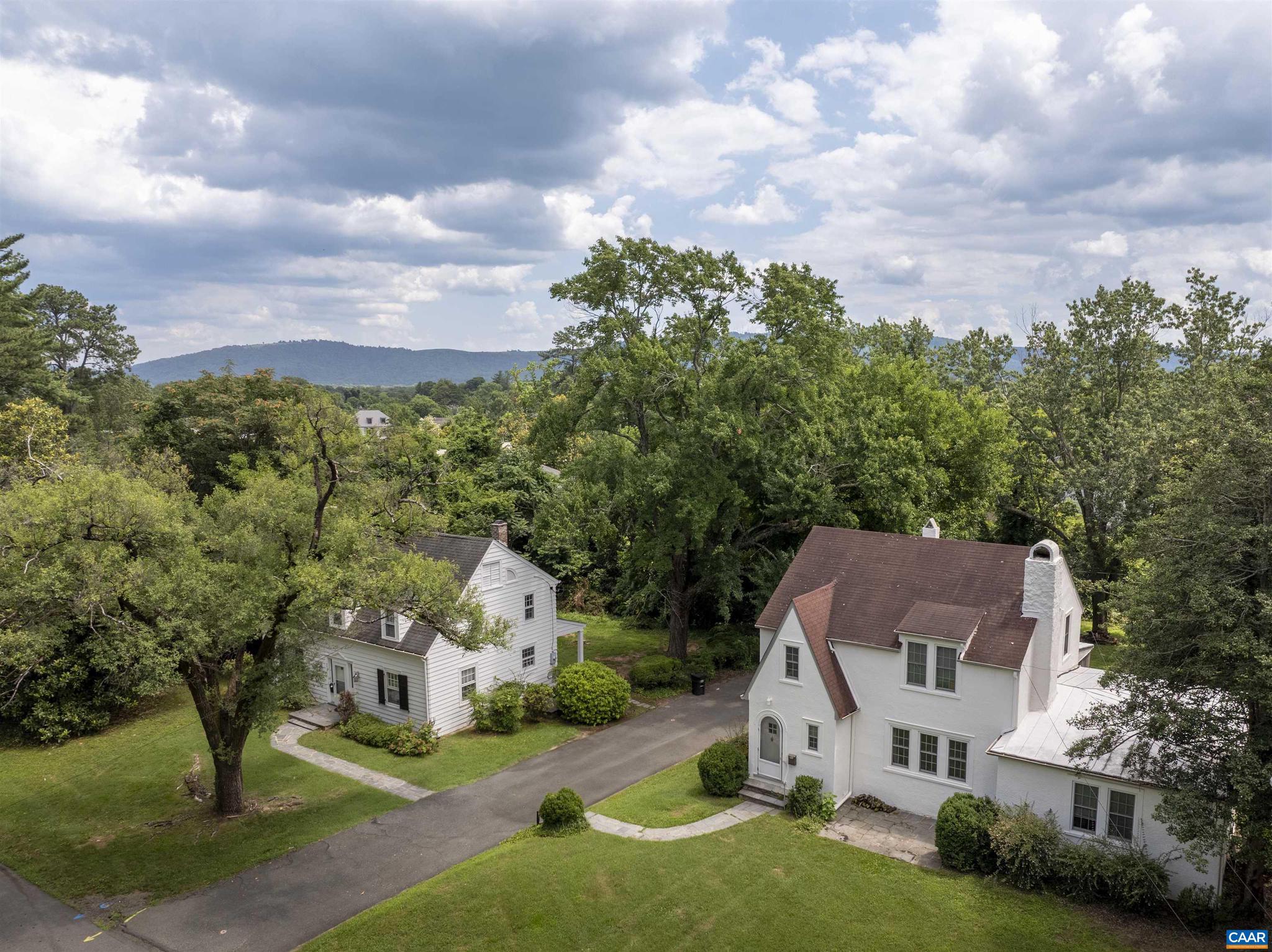 Unique opportunity to purchase TWO houses on Stadium Road. Both parcels combined total .71 acres in a prime UVA-adjacent location, right across the street from Runk Dining Hall. Each house is character-rich with many original details preserved, including hardwood floors, craftsman-trim, original glass doorknobs, plaster walls, built-ins (2203), gas fireplace with brick surround (2201), an incredible stone fireplace (2203), generously-sized spaces, and dedicated dining rooms. Large, level lot is a rare find in Charlottesville. 2201 is 3 bedrooms, 1.5 bathrooms. 2203 is 3 bedrooms, 2 full bathrooms with an attached, separately metered apartment that is 1 bedroom, 1 full bathroom (no kitchen). These houses are GEMS, with some updates they could be fantastic single-family homes or upscale rentals. OR, consider the future possibilities of increasing density in a prime UVA location.,Fireplace in Living Room