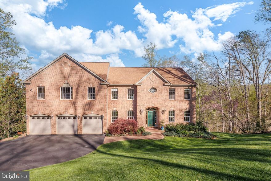 Extraordinary estate home, set on 2.44 private acres with over 440 feet of direct frontage on the Occoquan River. With nearly 5,500 square feet of luxurious space, this property offers a rare combination of grandeur, serenity, and natural beauty—just minutes from everyday conveniences. The main level welcomes you with a dramatic grand foyer, gleaming hardwood floors, and a flowing floor plan designed for both elegant entertaining and comfortable daily living. Formal living and dining rooms provide classic sophistication, while a private office offers a quiet retreat for work or study. The spacious family room features vaulted ceilings, skylights, and a cozy gas fireplace, seamlessly connecting to a large, light-filled kitchen with breakfast area and direct access to a deck overlooking the river—perfect for morning coffee or evening gatherings. Upstairs, the expansive owner’s wing is a true sanctuary, boasting cathedral ceilings, a wall of windows that frame breathtaking views, and a private deck, sitting room with a two-sided gas fireplace and built-in glass shelving. Two walk-in closets, a spa-inspired ensuite bath with dual vanities, soaking tub, and separate shower, create the ultimate retreat. Two additional large bedrooms, each with ensuite baths, complete the upper level with style and comfort. The fully finished lower level extends the living space with a 2nd family room complete with full-size windows, a walk-out to a screened porch, and access to the pathway leading down to the riverbank. Two more spacious bedrooms and a fourth full bathroom make this level perfect for guests, multi-generational living, or entertaining. Additional highlights include a 3-car garage, heated driveway for year-round ease, storage garage in the back of the house for your lawn equipment, and a peaceful, natural setting that brings the river to your doorstep. Don’t miss this rare opportunity to own a true waterfront retreat with timeless elegance and unmatched views.