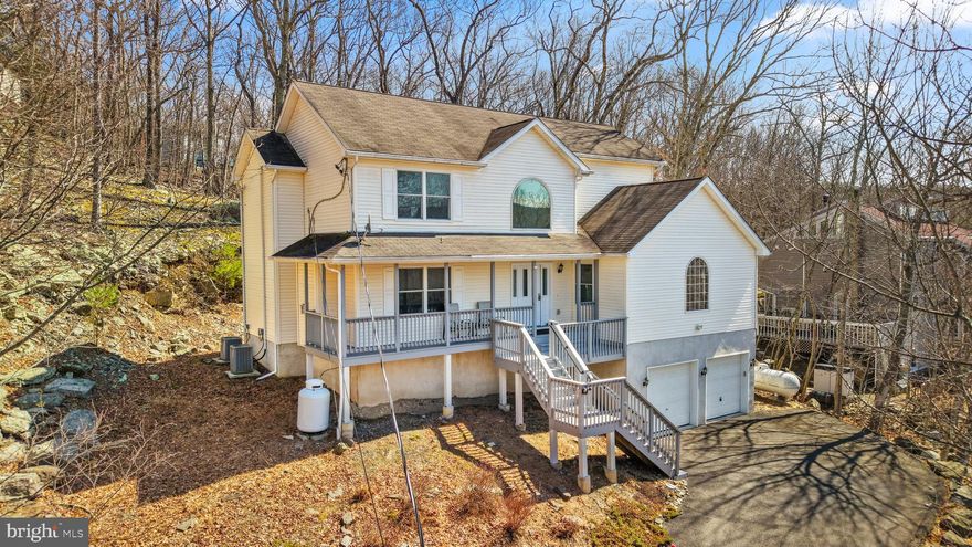 The Ultimate Forever Home or Weekend Retreat! Discover the perfect Poconos escape in Saw Creek Estates, a premier 5-star gated community renowned for its resort-style amenities. This beautifully remodeled 4-bedroom, 4-bathroom Contemporary home offers the ideal blend of modern style and mountain comfort. Main Level Living & Entertaining: Step into an expansive open floor plan featuring a gourmet kitchen with granite countertops, a center island, and a sunny breakfast nook with glass doors leading to the back deck. The formal living room is anchored by a stone fireplace, perfect for cozy nights. This level also includes a formal dining room, a convenient 1st-floor bedroom, and a family room with durable, modern vinyl plank flooring. Private & Spacious Quarters: Upstairs, the master suite is a sun-drenched sanctuary with a private, luxury master bathroom. The fully finished basement adds incredible living space, featuring a large recreation room and an additional bathroom--ideal for a home gym, theater, or guest suite. Peace of Mind & Exterior Features: Rare find: This home includes a Full House Generator and owned propane tanks, offering significant savings and reliability. Enjoy the outdoors from your welcoming front porch or the private rear deck. Complete with an attached 2-car garage and 24/7 gated security, this home is move-in ready for your next chapter. Ask how to receive up to $5,000 lender credit towards closing costs or lowering your interest rate!