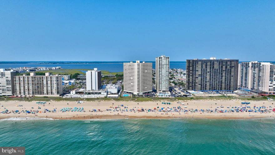 Welcome to your dream beachfront oasis at the Atlantis condominium in Ocean City, Maryland. This exquisite unit offers the perfect blend of luxury, comfort, and breathtaking coastal views. With two bedrooms and two full baths, it provides a spacious and serene escape for beach lovers. As you step inside, you'll immediately be enchanted by the neutral coastal color palette that creates a calming atmosphere, evoking the soothing hues of the ocean and sand. The luxury vinyl plank flooring adds a touch of elegance while maintaining a practical and easy-to-maintain surface, perfect for sandy toes coming in from the beach. The tasteful furnishings that complement this units interior are being included in the sale. The heart of this unit is the beautifully upgraded kitchen adorned with granite counters and decorative backsplash that seamlessly combine style and functionality. A breakfast bar overlooks the open dining and living area, perfect for entertaining friends and family. The enclosed balcony offers panoramic views of the beach and ocean below. Imagine waking up to the sound of gentle waves and stepping out to this private haven to watch the sunrise over the water. Two bedrooms and two full baths offer comfort and tranquility, with the primary suite being particularly captivating as it boasts its own waterfront views. The Atlantis condominium building is a true gem, conveniently located mere steps from the sandy shores of the beach. After a day of sun and surf, you can enjoy a refreshing dip in the community pool, creating an all-encompassing resort-like experience. Immerse yourself in the coastal charm, stunning views, and luxurious amenities, and experience the ultimate beachfront lifestyle that Ocean City, Maryland has to offer.