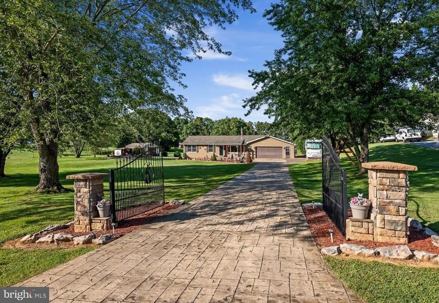 Country roads take you home to this lovely ranch-style estate. Where do we start; the front iron gates or the in-ground pool??? This one owner, 3 bedroom, 2 bath home on 1+ acres has had many updates and upgrades with no details left behind. Enter the property through the gated, lengthy stamped concrete driveway. Around back you’ll find a wrought-iron fenced in, in-ground pool with stamped a concrete patio surround and lounging area that has overhead coverage and ceiling fans for those super-hot summer days, plus lots of level yard space to play and entertain guests. Or enjoy working in the 18x26 metal building with a 13x26 overhang tinkering with your extra vehicles or toys. The large wood walk-in shed also conveys. Inside the home, gorgeous hardwood floors run throughout. The eat-in kitchen has quartz countertops, stainless steel appliances and travertine tile flooring. There are two living room areas to relax, one with a vent-free gas fireplace. 3 nicely sized bedrooms share a full hall bathroom with a standup showing and lovely soaking tub. The attached climate control two car garage holds the laundry area and a half bathroom and has a rear entry to the backyard where you’ll find the covered sitting area to relax poolside. The immaculate grounds offer extra parking next to the garage with a 50amp RV plug. *** New hot water heater in 2023, roof and siding replaced approx. 5 years ago. This house is move-in ready and won’t last long, schedule your showing now!