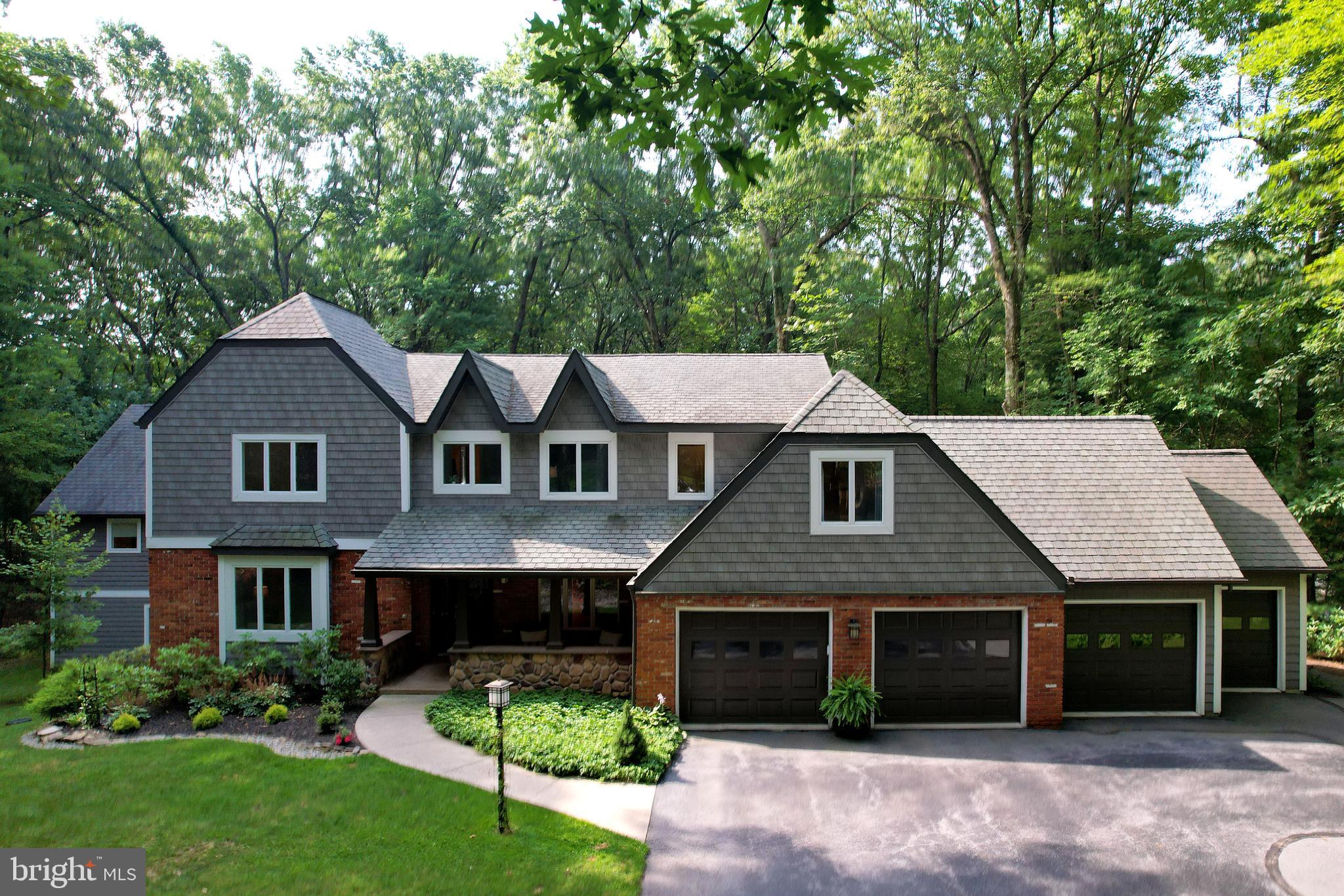 OPEN HOUSE - Sunday, August 3rd, 11:00 AM - 12:30 PM.
Nestled just across the street from hundreds of acres of the Pennsylvania Game Lands you'll find 1321 Deerfield Drive a truly one of a kind home in highly sought after Greenbriar. This 6 bed, 6.5 bath house sits on 1.3 picturesque acres and has all of the warmth and welcome of a classic craftsman style home throughout its impressive 7000+ square feet including a huge addition perfect for working from home, inter-generational living, and much more! From the moment you step inside you'll be greeted with stunning warm wood trim, soft yet abundant lighting, beautiful hardwood floors, craftsman fixtures, and a cozy elegance that's hard to duplicate. You'll love hosting your social circle for afternoon tea in the sunken living room with big windows or snuggling up with your favorite book in the sweet den. A home chef's delight, the updated kitchen features beautiful custom Amish wood cabinetry, a huge kitchen island, granite countertops. tile backsplash, five burner gas range, double wall oven, stainless steel appliances, and sweet built-in desk area perfect for homework or meal planning. Share moments big and small in the beautiful dining room with stately stone fireplace with wood mantle and stained glass accents. Or enjoy a late dinner under the stars on your large composite deck overlooking the quiet backyard. You'll appreciate the main level laundry room and half bath as well as the nicely sized pantry! Upstairs you'll discover a serene primary suite with stylish vaulted ceilings, attached bonus space great for an office, sitting room, or nursery, impressive built-ins, and a private bath with skylight, soaking tub, and walk-in tiled glass shower. A second ensuite with private bath and WIC provides a wonderful space for your loved ones as do the two additional nicely sized upper level bedrooms and shared hall bath! The finished lower level features a family room with laminate flooring ideal for a play space, exercise room, or media room as well as a bonus room great for guests and full bath! Behind the dining room you'll find access to the addition by way of the wonderful four seasons room with exposed brick interior and full window exterior walls perfect for winter afternoons. Built by DeHaas Builders, the main floor of the addition boasts an open floor plan featuring a double sided gas fireplace and wall of windows to the back with a living room and sleeping area, as well as a kitchenette, walk-in closet, and giant full bath with soaking tub, walk-in shower, and dual vanities. Downstairs you'll find a second family room area with same wall of windows to the back, full bath, 2nd laundry, and bedroom, currently being used as an office - the possibilities of this space are abundant including a great private studio apartment for a loved one who wants a touch of independence (this space has a separate exterior entrance from the back of the home for privacy) or work from home space. Spend cool autumn evenings around the peaceful backyard fire ring or sunny summer days gardening to your hearts delight in the stunning partially wooded private yard with a built into the house garden shed. The three car garage also includes a 4th smaller bay for your lawn equipment. You'll love this quiet non-HOA neighborhood with access to hiking and playing in the Gamelands while enjoying the convenience of being right in town for easy commuting to campus, downtown, schools, and shopping. If you've been searching for a home that has the space you need but doesn't sacrifice the sweetness of home sweet home, come check this beauty out today!