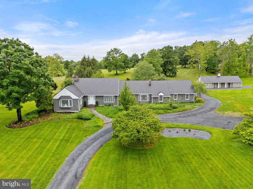 Grey Acres – Middleburg, Virginia
Nestled just minutes from the heart of historic Middleburg, Grey Acres offers a rare blend of scenic beauty, timeless charm, and refined country living. This exceptional 31.05-acre property—divided into three recorded parcels—boasts elevated building sites with sweeping views of the Blue Ridge and Bull Run Mountains.

The residence, originally built in 1960, has been masterfully reimagined by its current owners. Wrapped in classic cedar shake with a standing seam metal roof, the home features 3 bedrooms, 3.5 baths, and three fireplaces. Inside, rich wood floors run throughout, complemented by custom millwork and a paneled den that exudes warmth and sophistication. An oversized two-car garage completes the primary residence.

Equestrian amenities include a charming four-stall barn and an old riding ring, while the in-ground pool offers a peaceful retreat amid rolling open fields.

Grey Acres is a remarkable opportunity to enjoy the best of Virginia’s Hunt Country—privacy, views, and versatility—all within moments of Middleburg’s shops, dining, and vineyards.

Please see the attached list of thoughtful improvements made by the current owners.