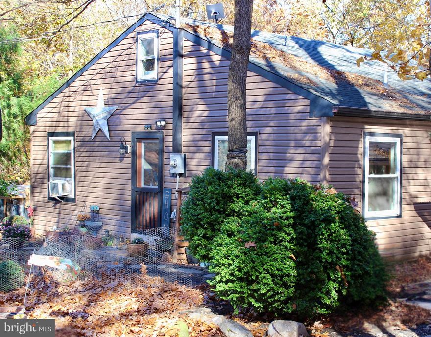 Escape to your own private sanctuary or seize an exceptional investment opportunity with this fully renovated storybook cabin, tucked away on nearly 17 acres of pristine mountain land. Surrounded by nature, this one-of-a-kind retreat is ideal for investors, Airbnb hosts, or anyone seeking a peaceful getaway with income potential. Inside, rich wood plank floors, soaring cathedral ceilings with exposed beams, and a striking Earth Works woodstove create a warm and inviting atmosphere that perfectly blends rustic charm with refined style.

The chef’s kitchen blends craftsmanship and modern luxury with a raw-edge oak countertop, hammered copper farmhouse sink, open shelving, and a custom wood-hood inspired by the surrounding forest. High-end appliances include a ZLINE 6-burner gas range with grill, Café refrigerator with copper accents, and full-size GE washer and dryer all just four years young. Recent upgrades include a new well pump, water heater, and pressure tank for total peace of mind.

The whimsical loft offers versatile space for an office, studio, or reading nook, while the bathroom showcases a repurposed oversized farmhouse sink and therapeutic soaking tub perfect for unwinding after a day outdoors. Step outside to enjoy breathtaking sunsets from the front porch, or take in panoramic mountain views from the private back deck.

Outdoors, discover a new woodshed, carport, chicken coop with matching storage shed, fenced yard, and a stunning 16’ x 16’ reclaimed-window & wood greenhouse. The land itself spans from mountaintop to valley, offering both seclusion and potential. Two prior perc test sites suggest subdivision possibilities (buyer to verify). Midway down the mountain, an unfinished off-grid 20’ x 30’ sky light filled cabin awaits your imagination ideal for a glampsite or Airbnb expansion or an author’s dream space, for writing inspiration.  

No HOA. No restrictions. Massive short-term rental demand this sought-after area enjoys 9 months of strong Airbnb and VRBO bookings each year, with supply unable to meet demand. Whether as a luxury retreat, multi-generational estate, or high yield income property, opportunities like this are exceptionally rare.  A must see! 

Private yet convenient to commuter routes this is mountain living at its most magical. 

Pre-qualified buyers only. Schedule your private showing today.