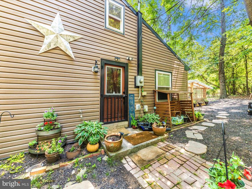 Escape to your own private sanctuary or seize a rare investment opportunity this 17-acre mountain retreat features two prior perc-tested sites, offering potential for subdivision (buyer to verify). Nestled on pristine land, the fully renovated storybook cabin blends rustic charm with refined style. Inside, rich wood plank floors, soaring cathedral ceilings with exposed beams, and a striking Earth Works woodstove create a warm, inviting atmosphere perfect for a peaceful getaway, Airbnb rental, or income-generating retreat.

The chef’s kitchen blends craftsmanship and modern luxury with a raw-edge oak countertop, hammered copper farmhouse sink, open shelving, and a custom wood-hood inspired by the surrounding forest. High-end appliances include a ZLINE 6-burner gas range with grill, Café refrigerator with copper accents, and full-size GE washer and dryer all just four years young. Recent upgrades include a new well pump, water heater, and pressure tank for total peace of mind.

The whimsical loft offers versatile space for an office, studio, or reading nook, while the bathroom showcases a repurposed oversized farmhouse sink and therapeutic soaking tub perfect for unwinding after a day outdoors. Step outside to enjoy breathtaking sunsets from the front porch, or take in panoramic mountain views from the private back deck.

Outdoors, discover a new woodshed, carport, chicken coop with matching storage shed, fenced yard, and a stunning 16’ x 16’ reclaimed-window & wood greenhouse. The land itself spans from mountaintop to valley, offering both seclusion and potential. Two prior perc test sites suggest subdivision possibilities (buyer to verify). Midway down the mountain, an unfinished off-grid 20’ x 30’ sky light filled cabin awaits your imagination ideal for a glampsite or Airbnb expansion or an author’s dream space, for writing inspiration.  

No HOA!! Massive short-term rental demand for this sought-after area enjoys 9 months of strong Airbnb and VRBO bookings each year, with supply unable to meet demand. Whether as a luxury retreat, multi-generational estate, or high yield income property, opportunities like this are exceptionally rare.  A must see! 

Private yet convenient to commuter routes this is mountain living at its most magical. 

Pre-qualified buyers only. Schedule your private showing today.